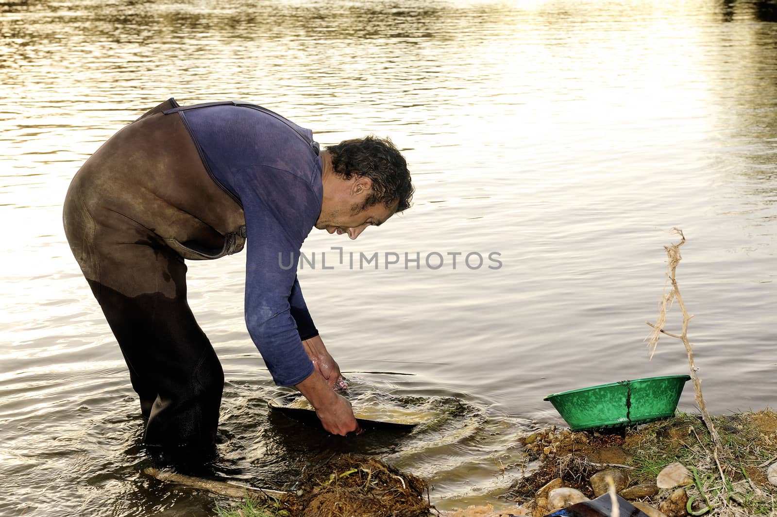 Gold digger in France in the region of Cevennes and the department of Gard in the middle of the river called Le Gardon.