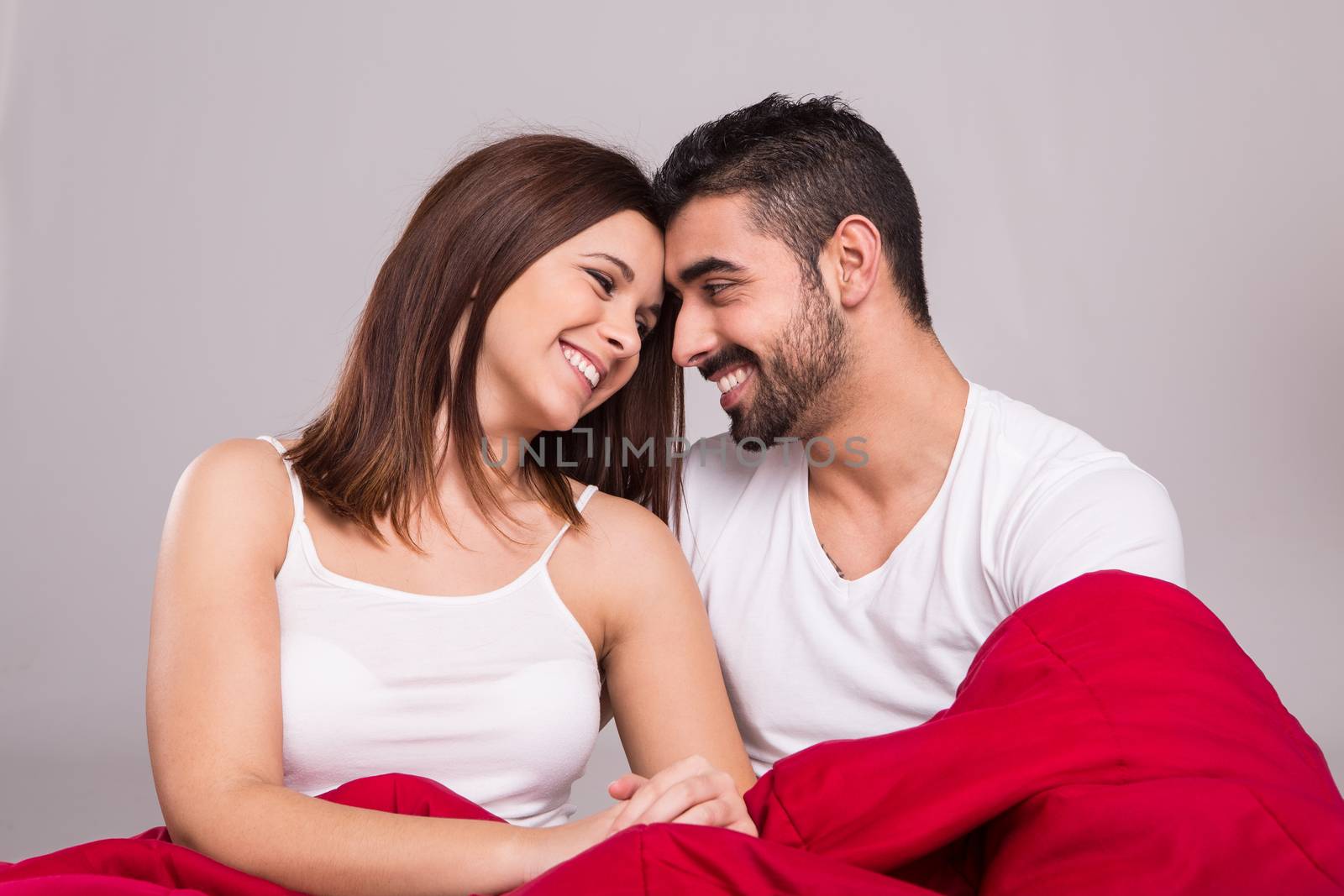 Young love couple relaxing together in bed 