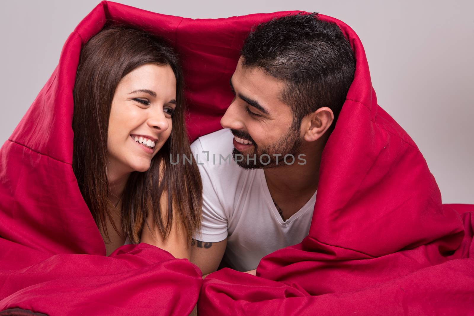 Young love couple relaxing together in bed 