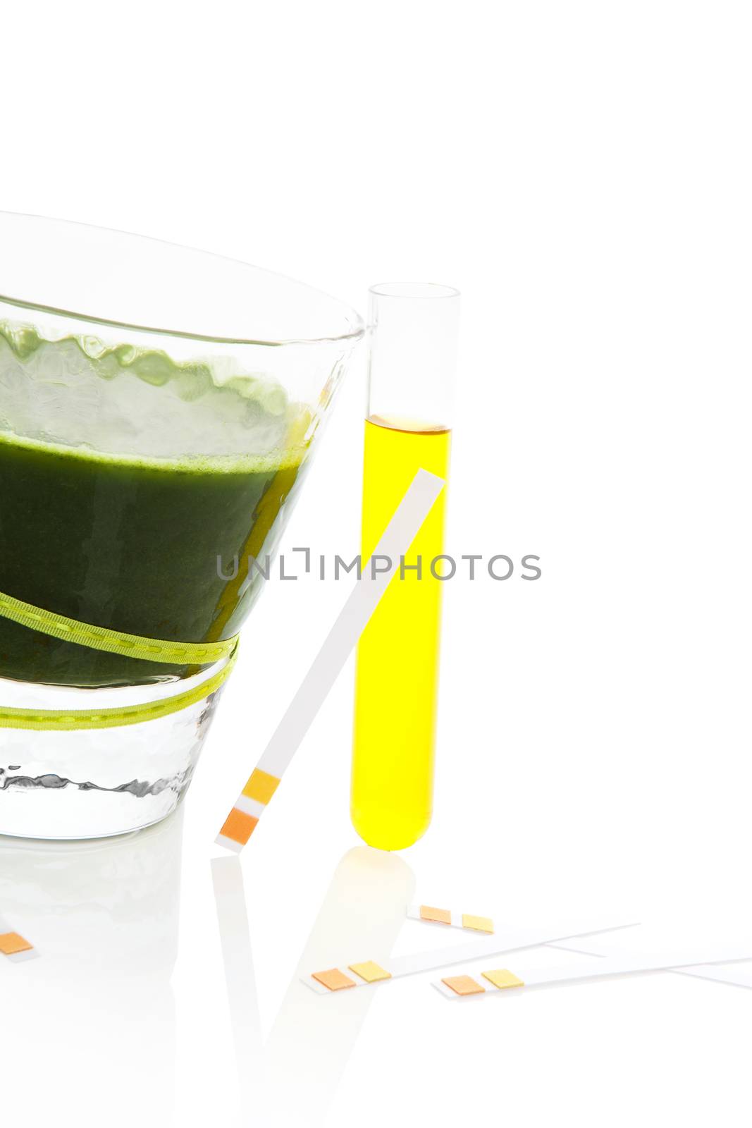 PH test strips, litmus paper and urine in test tube, glass with green juice isolated on white background. Minimal medical health care background.