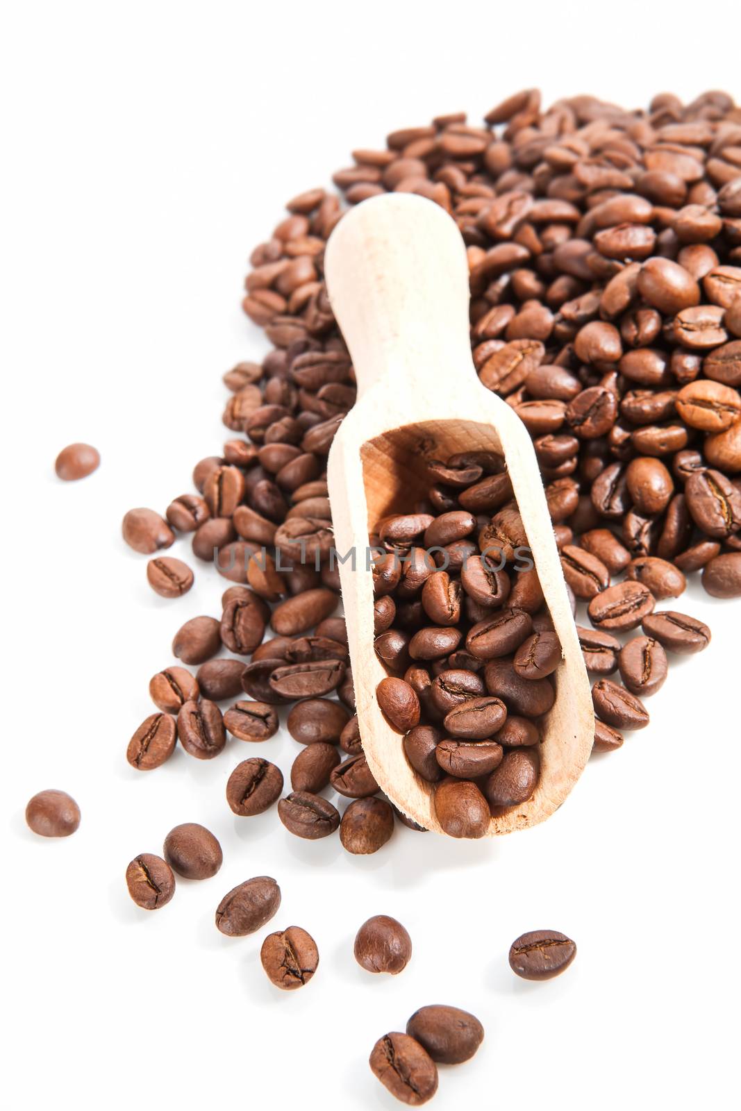 Coffee beans with wooden scoop. by eskymaks