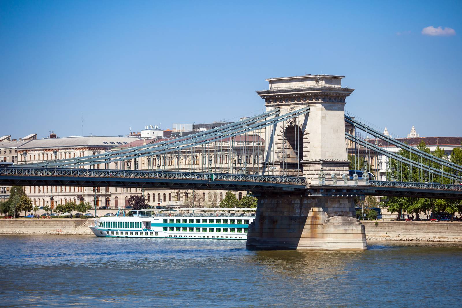 Cruise ships on Danube river with Chain Bridge in front  and Parliament Building in the background, Budapest.