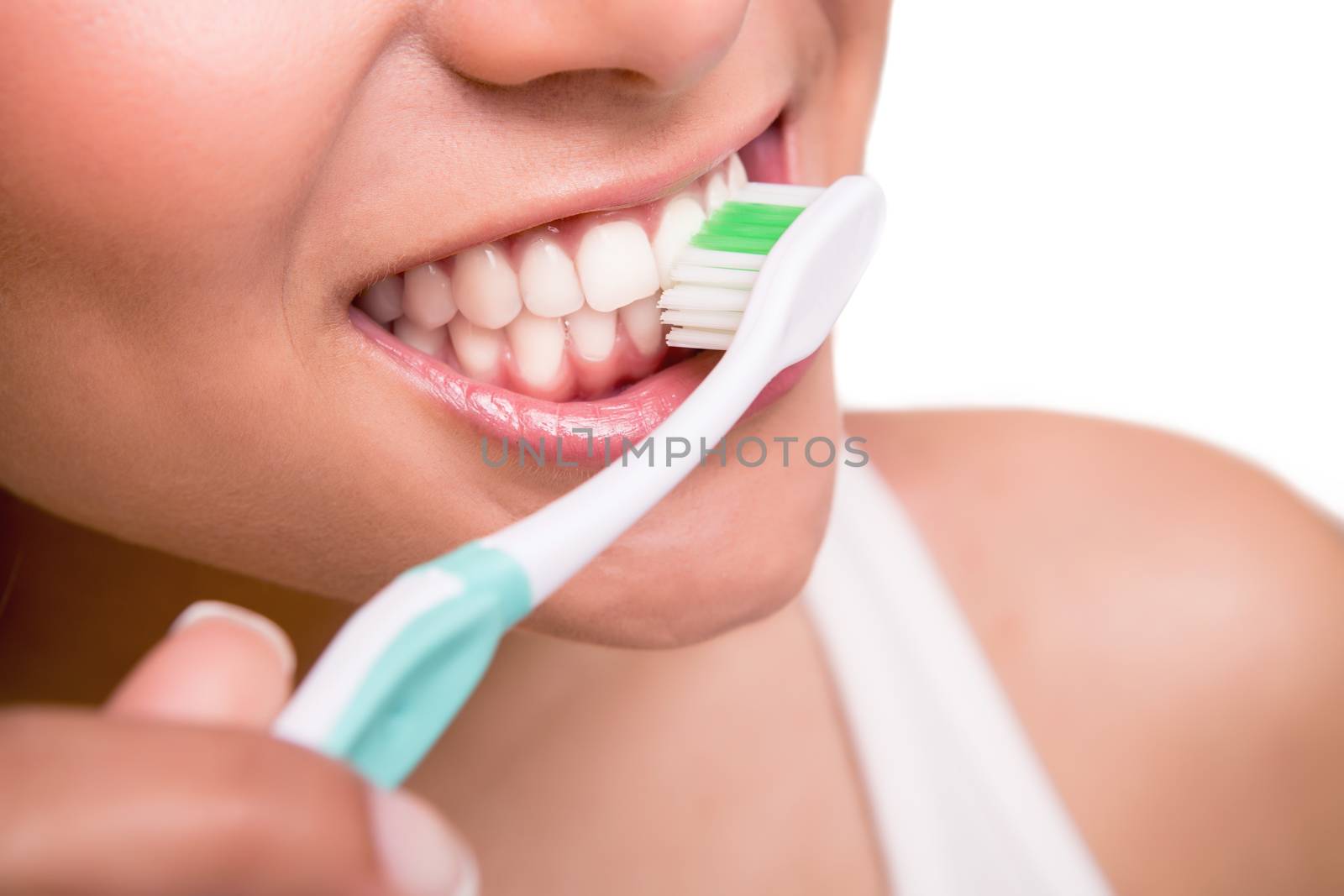 Smiling young woman with healthy teeth holding a tooth brush