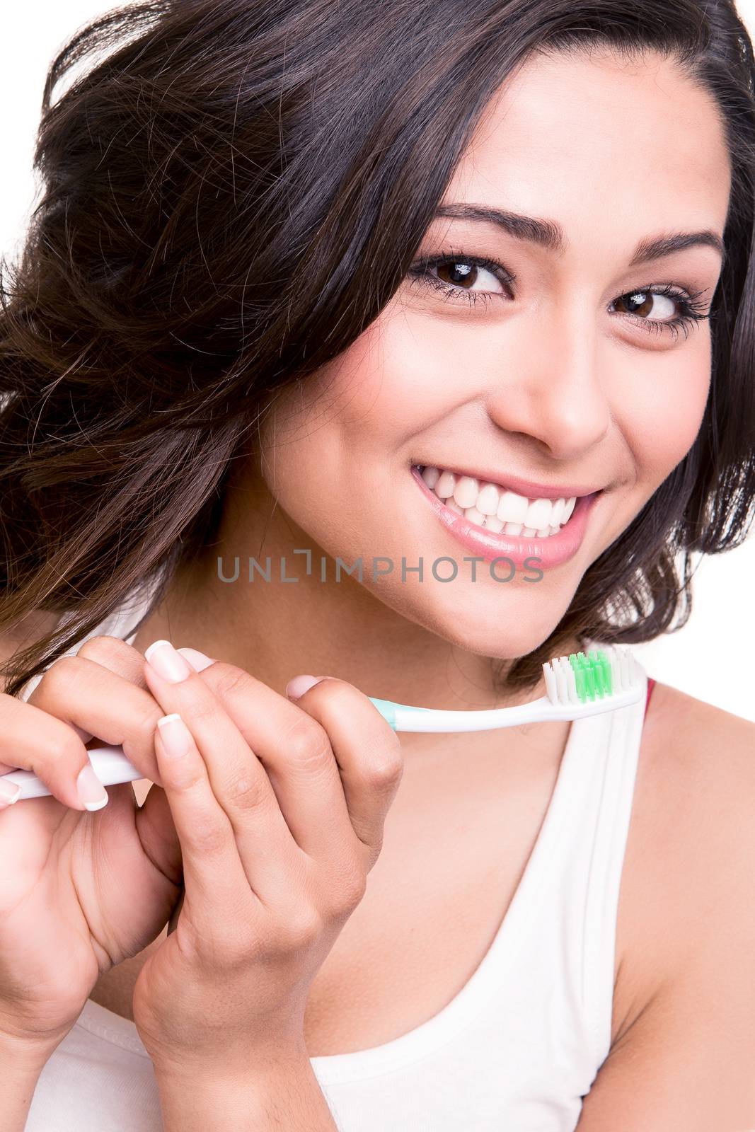 Smiling young woman with healthy teeth holding a tooth brush