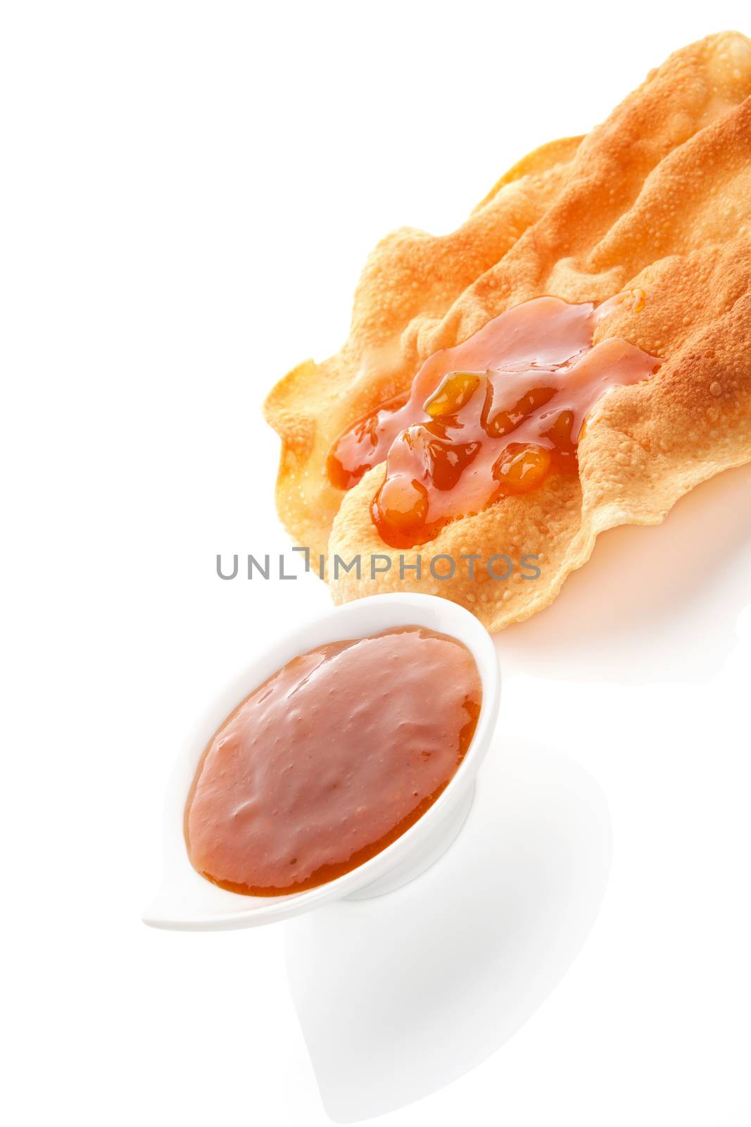 Delicious papadam with mango chutney in bowl isolated on white background. Culinary indian cuisine.