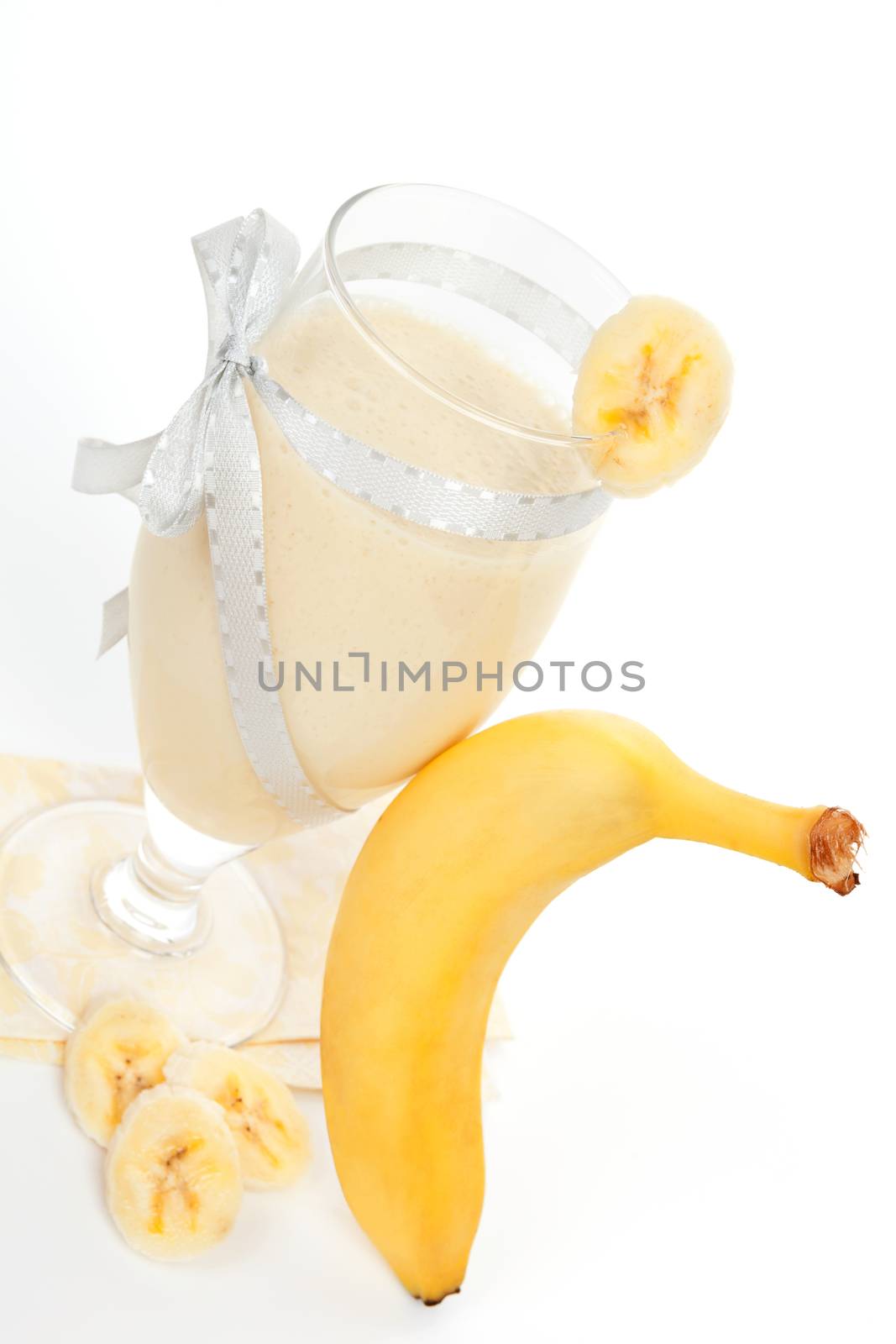 Delicious banana shake background. Fresh banana and milkshake isolated on white background. Fresh summer drinking.