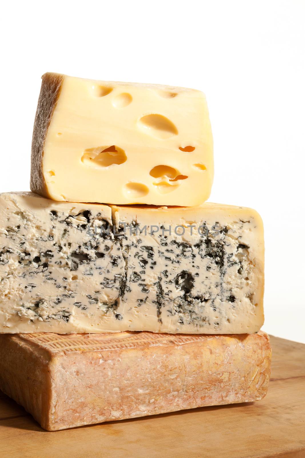 Three huge various cheese black on wooden background. Culinary cheese background.