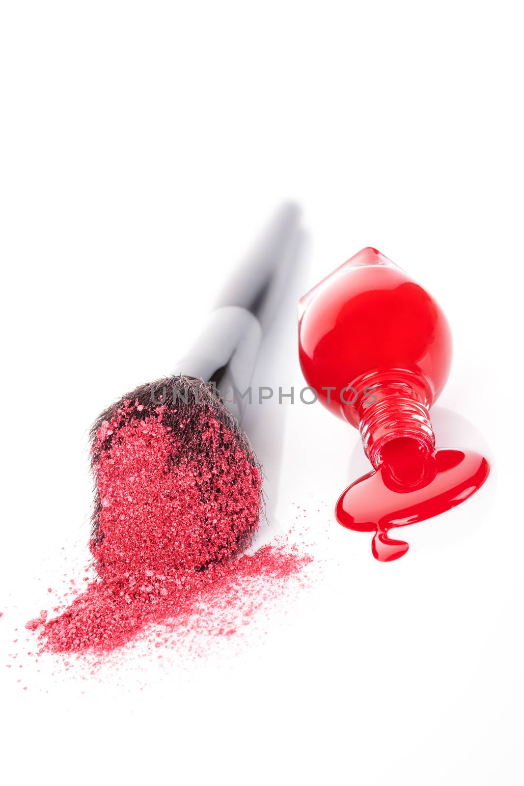 Luxurious cosmetics background in red and white. Red nail polish and makeup brush with pink powder isolated on white background. Feminine beauty concept.