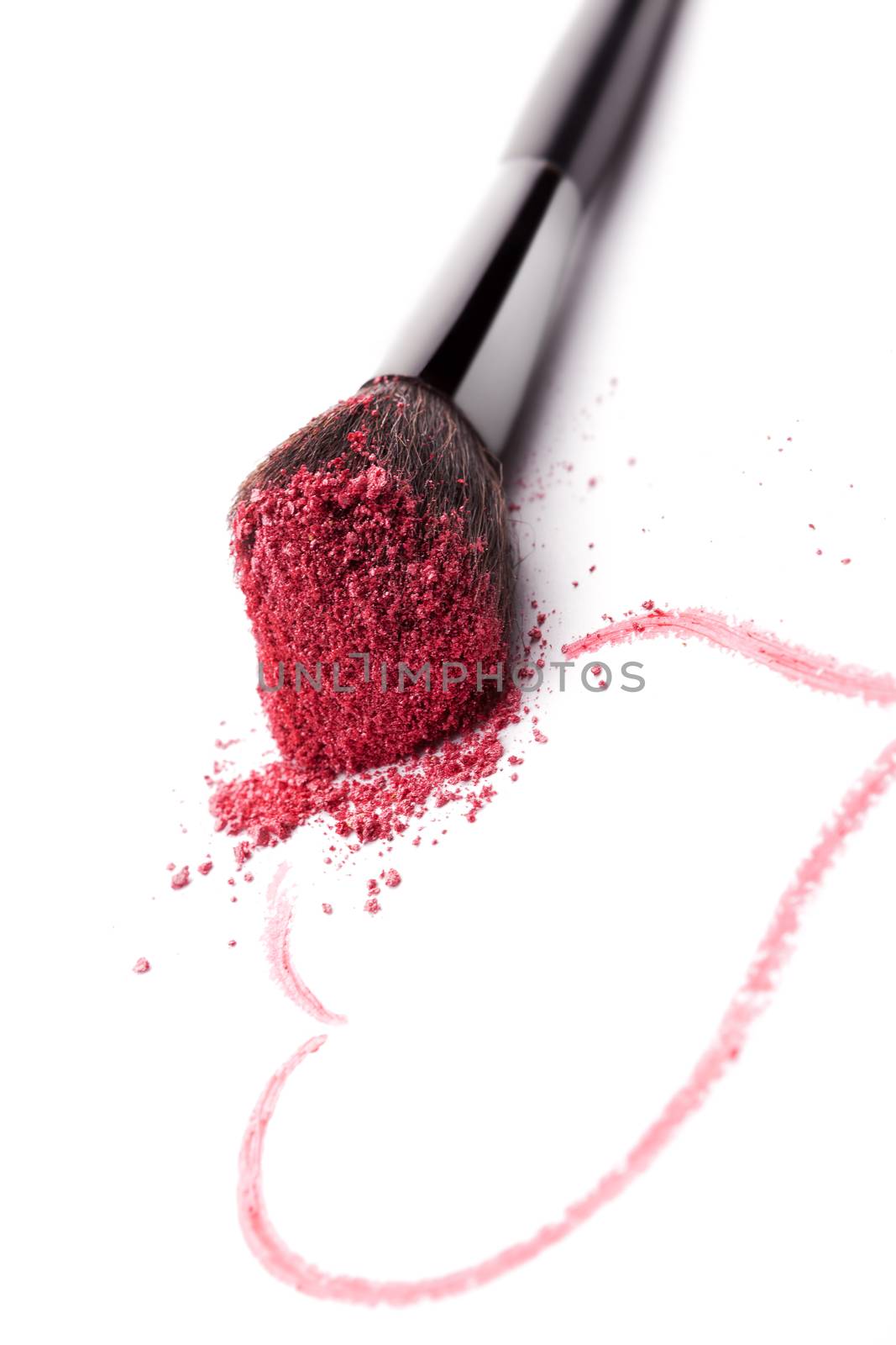 Glamour makeup background. Brush with purple makeup powder and heart drawn with lipstick isolated on white background. Beauty and love background.