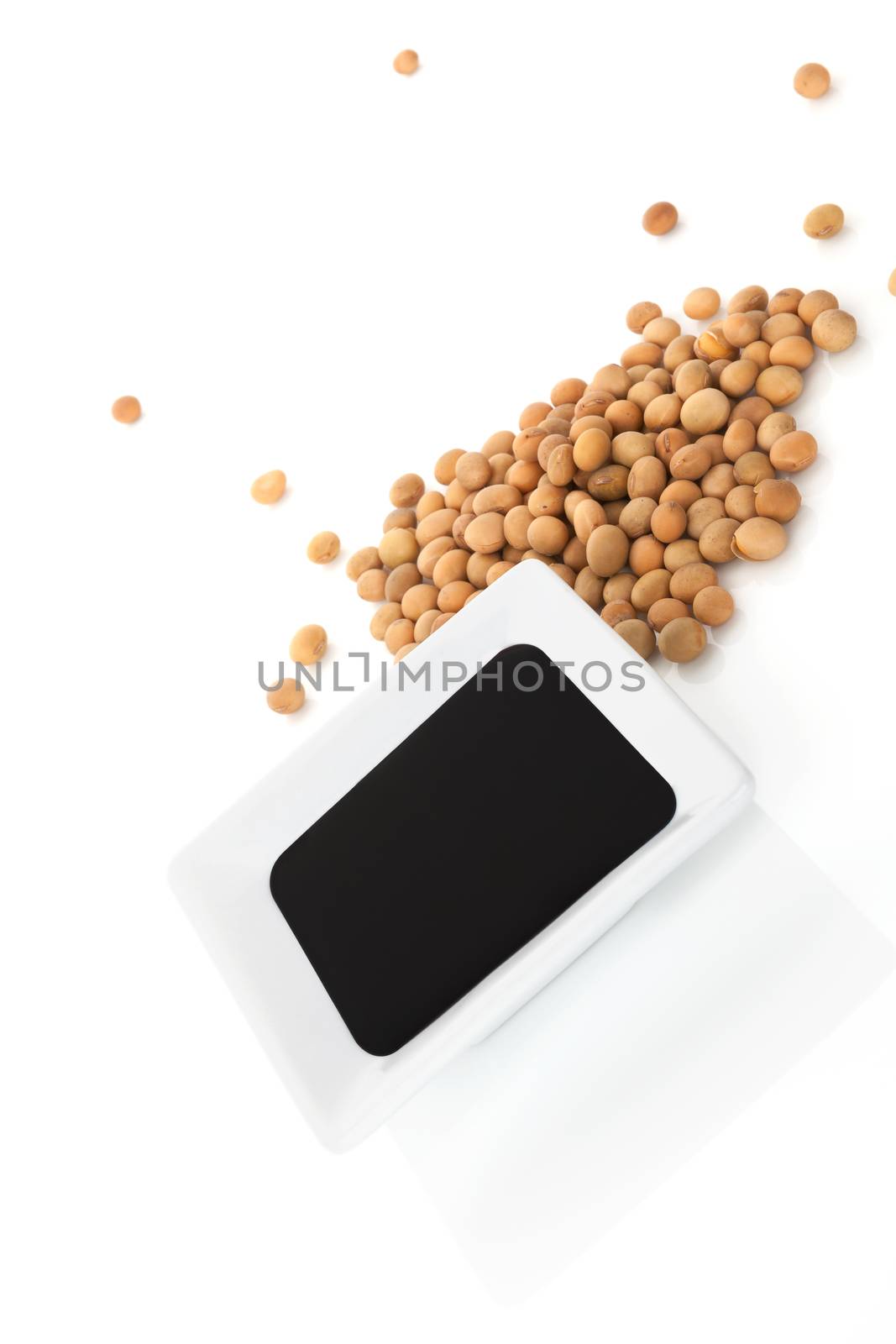 Soy sauce and soybeans isolated on white background. Soy and fermented soy product. Vegan and vegetarian eating concept.