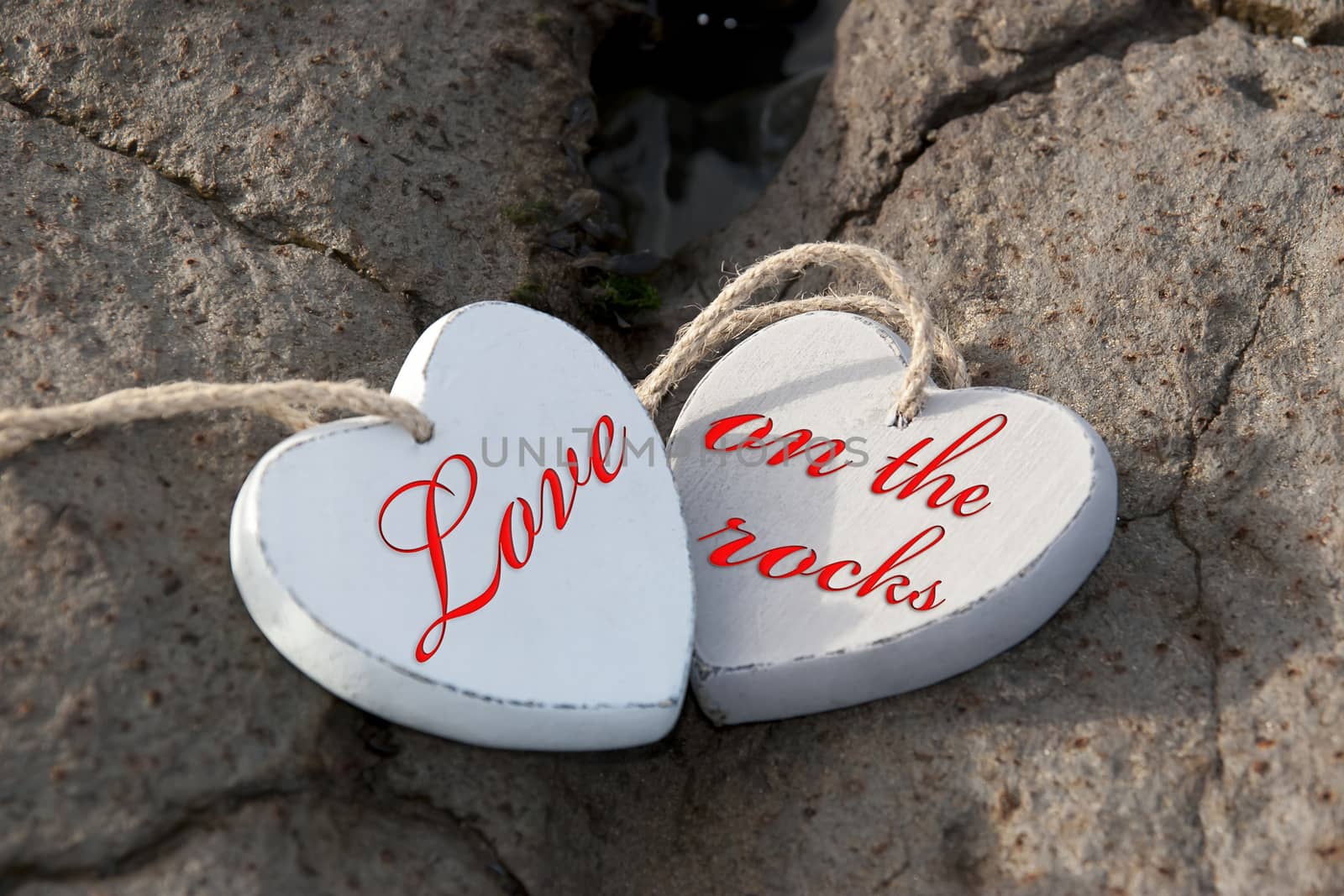 two wooden love hearts on the sand banks of an Irish beach in county Kerry