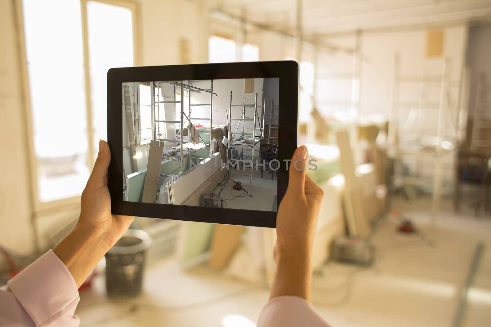 Architect woman working with electronic tablet, takes a picture by LDProd