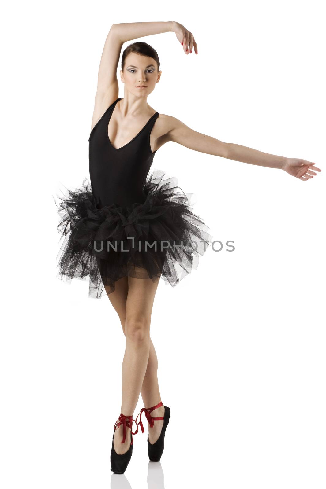 classic dancer with black dress and shoes on white background dancing on pointe