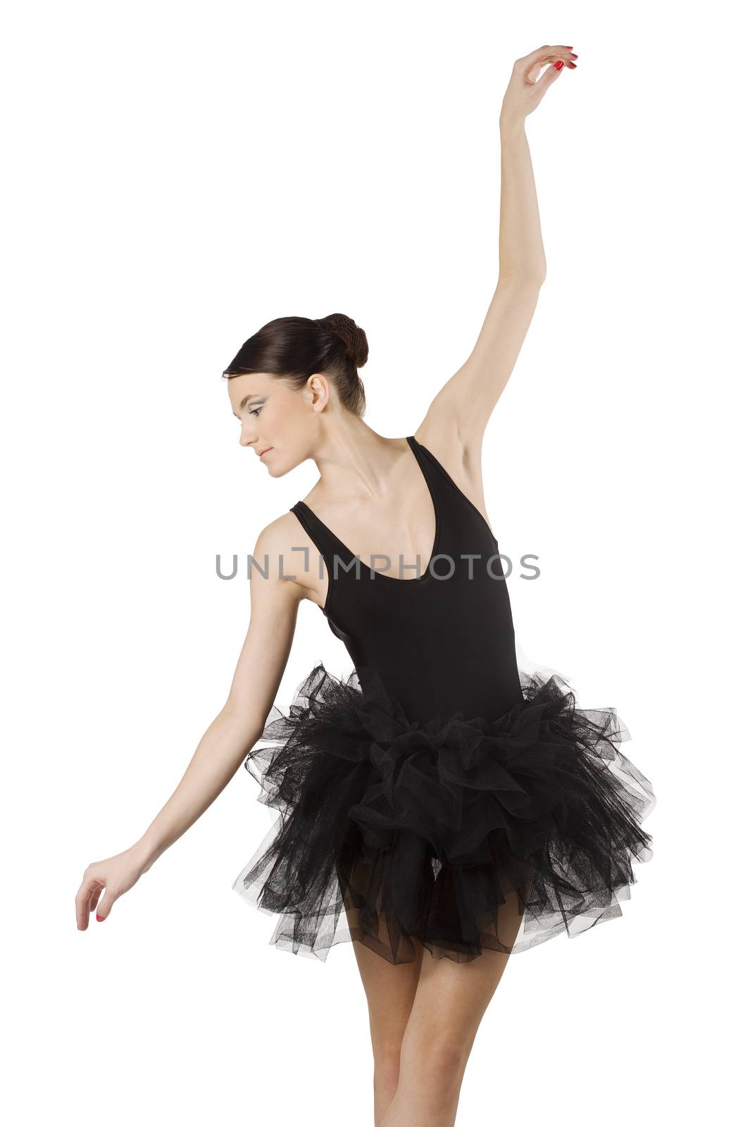graceful ballerina in black tutu taking a classical dancing pose looking down