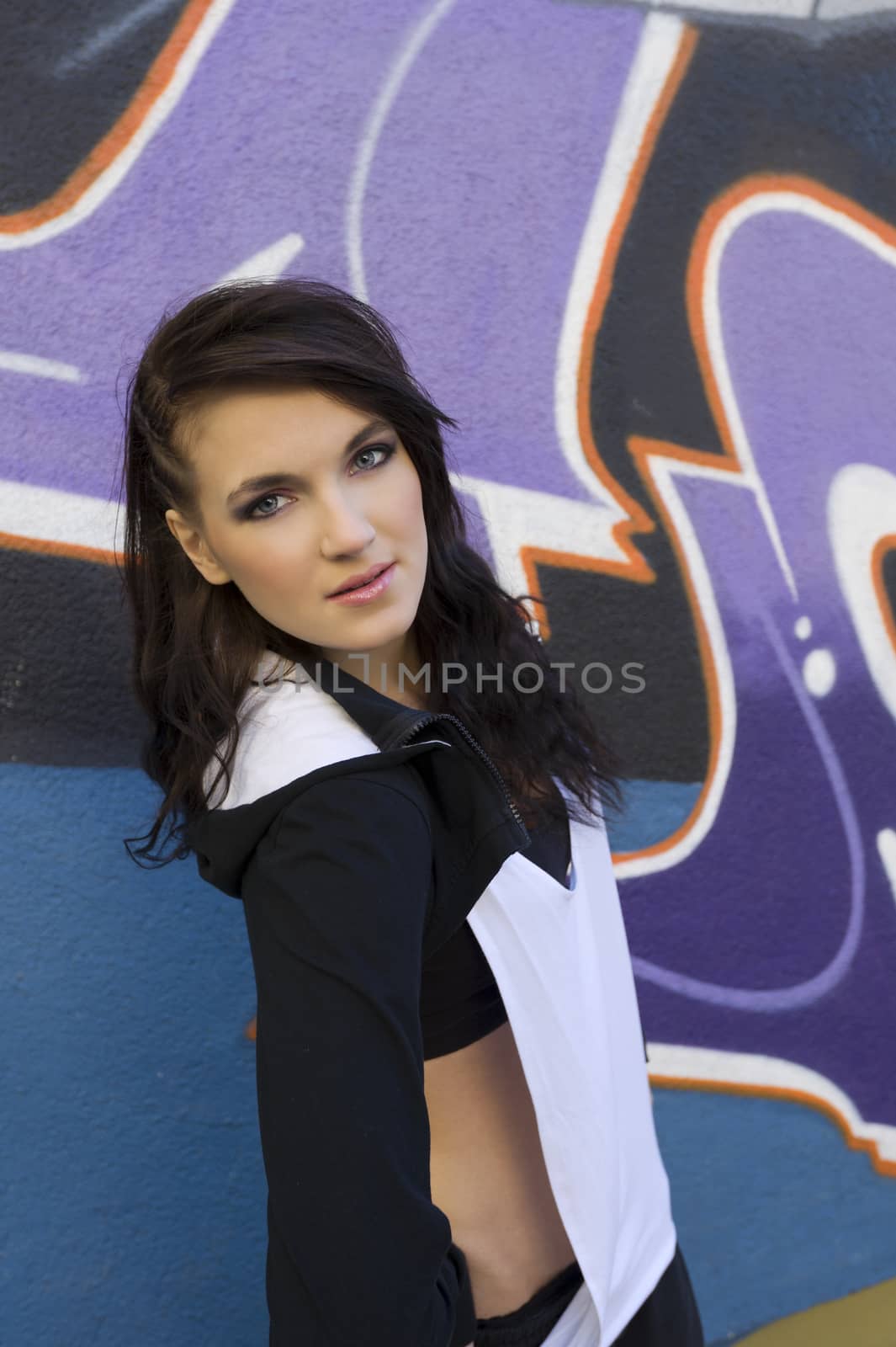close up portrait young attractive woman in hip hop dress in urban background