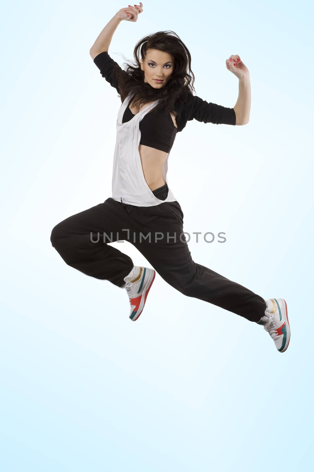 stunning brunette dancer in modern style flying in acrobatic pose