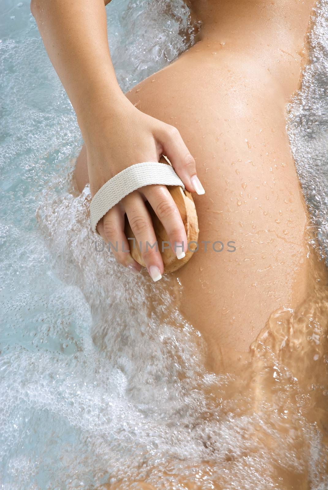 close up of a woman body scrubbing herself in a whirpool