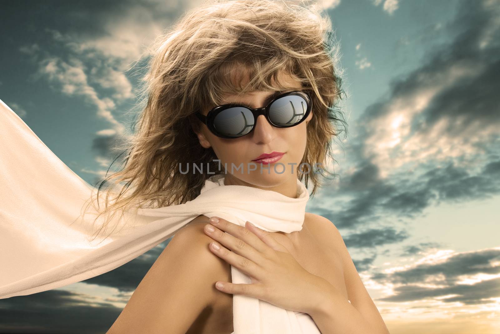 blond girl with a silk scarf and sun glasses in a vintage portrait