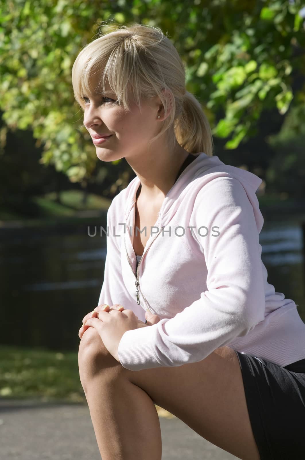 blond girl making gymnastic in a sunny day outdoor
