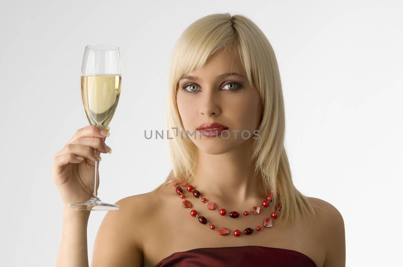 cute blond with cup of champagne in act to toast in fashion color
