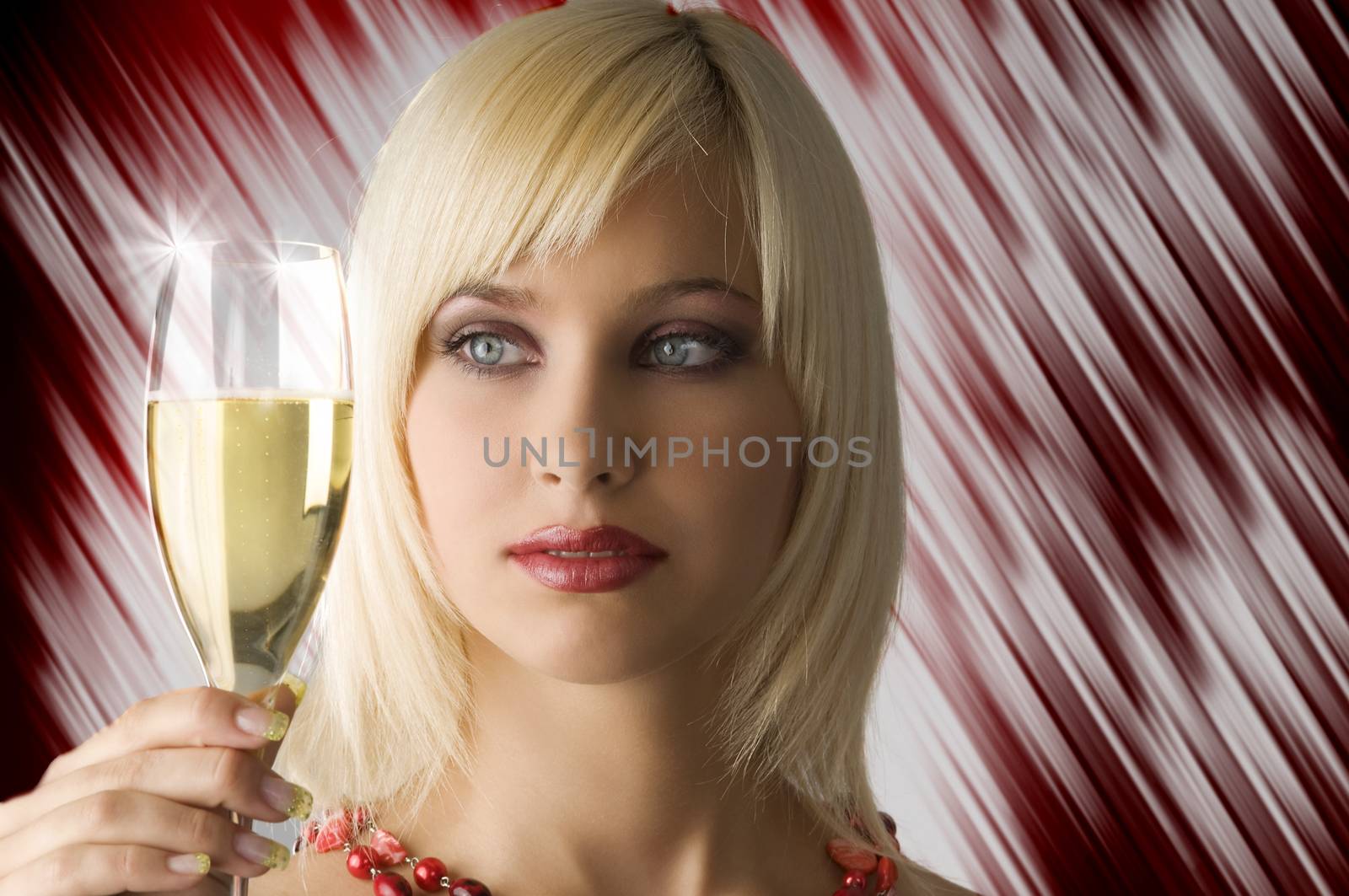 cute blond watching a cup of champagne and having red necklace