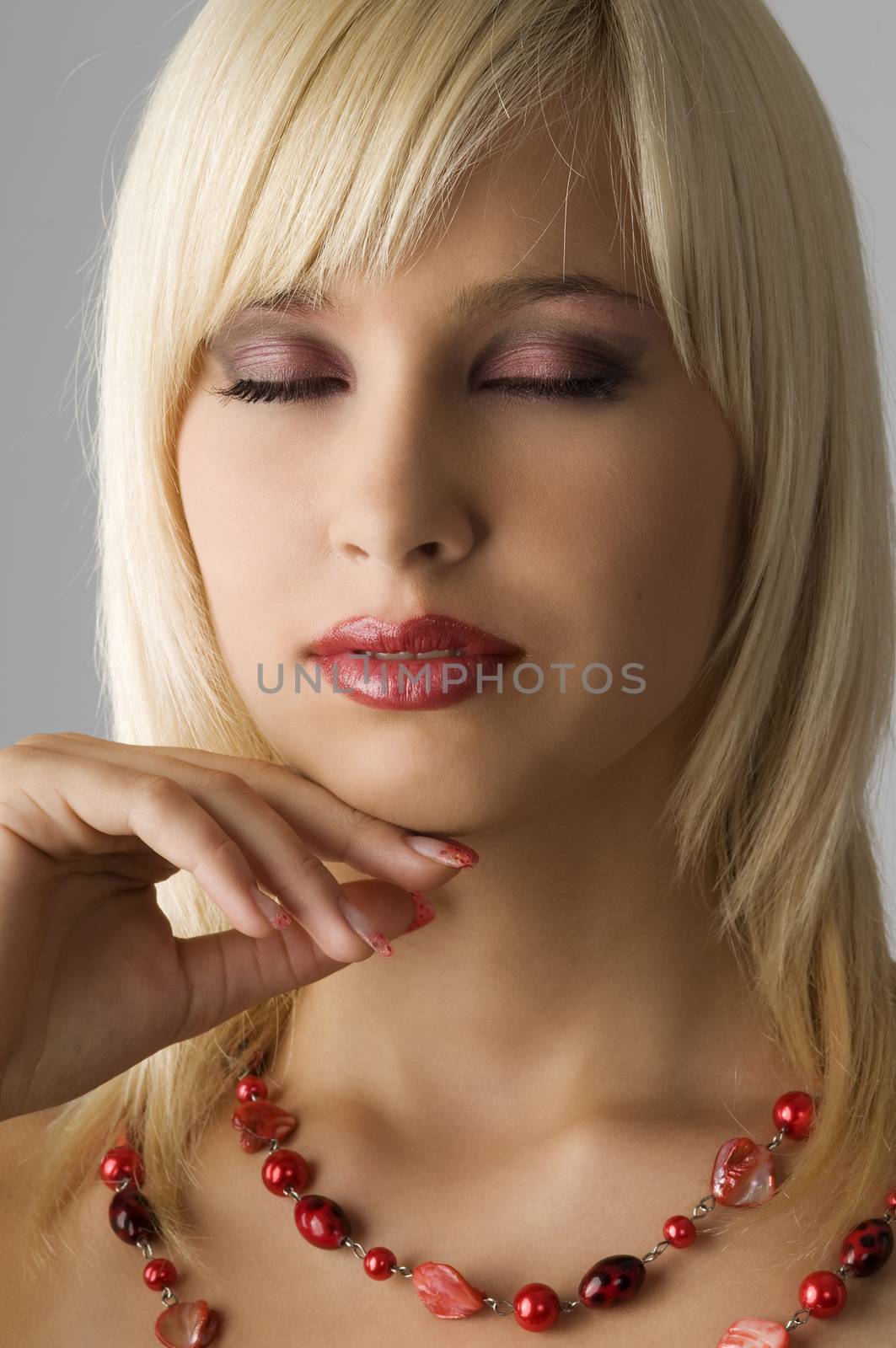 cute blond girl with glamor make up with red necklace