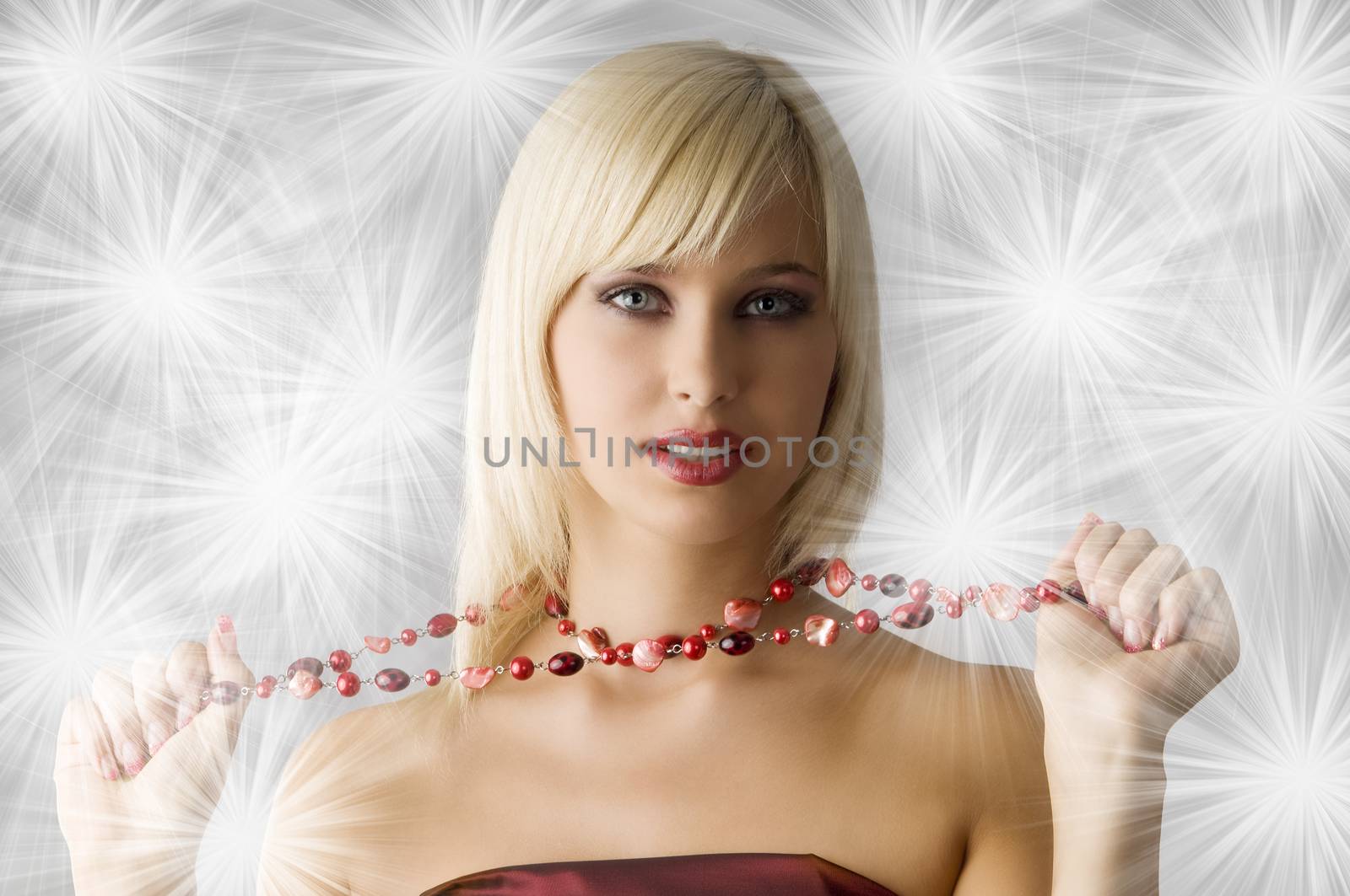 cute blond girl with glamour make up pulling a red necklace