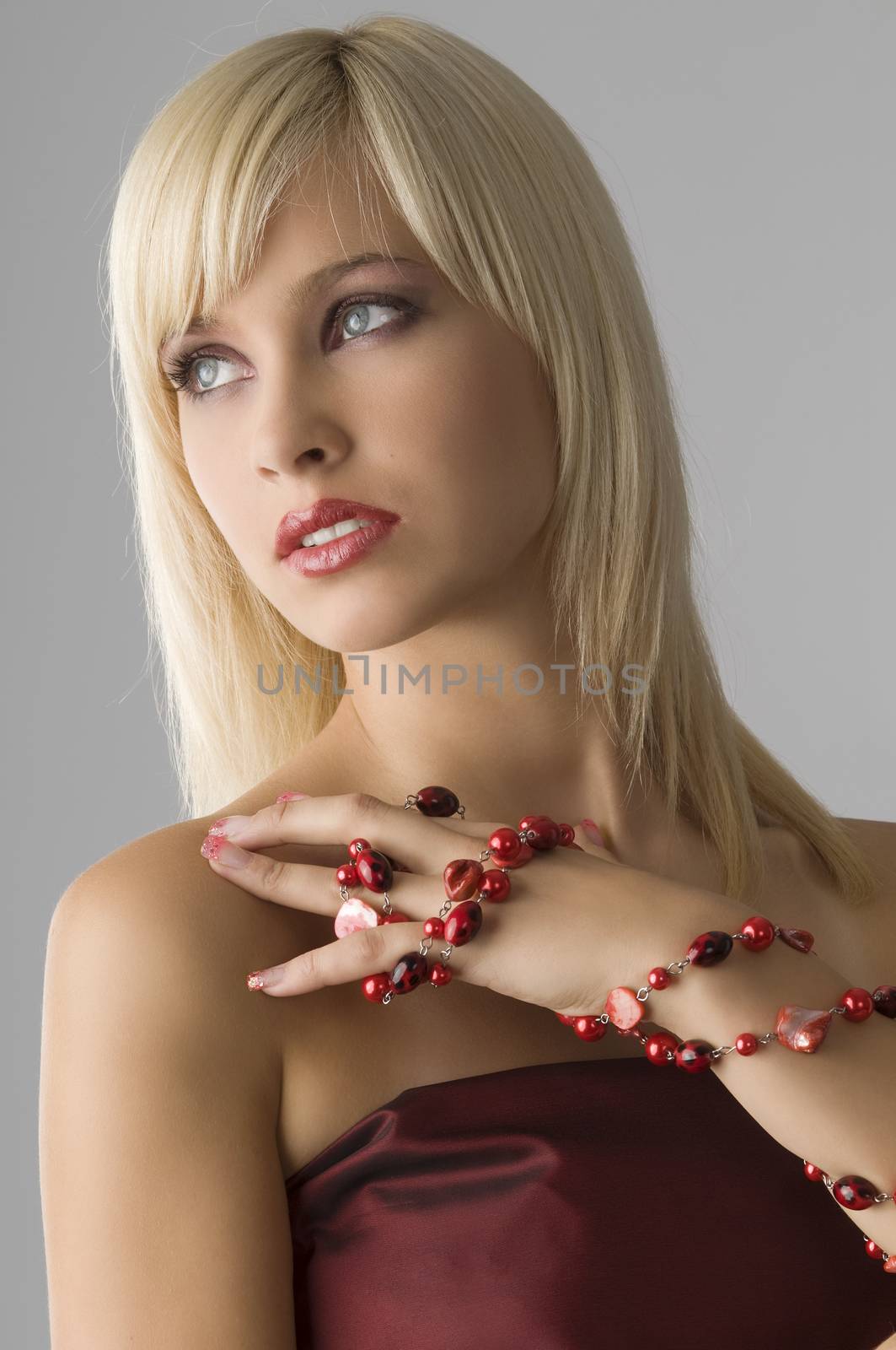 cute blond girl with glamor make up with red necklace
