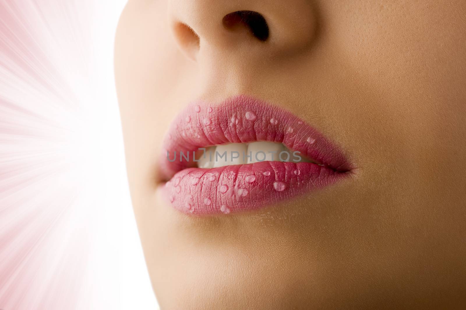 close up of woman mouth with pink lipstick and water drops on her lips