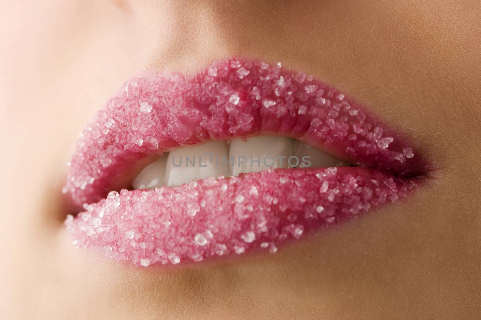 Woman's red lips coated with scattered sugar showing tooth