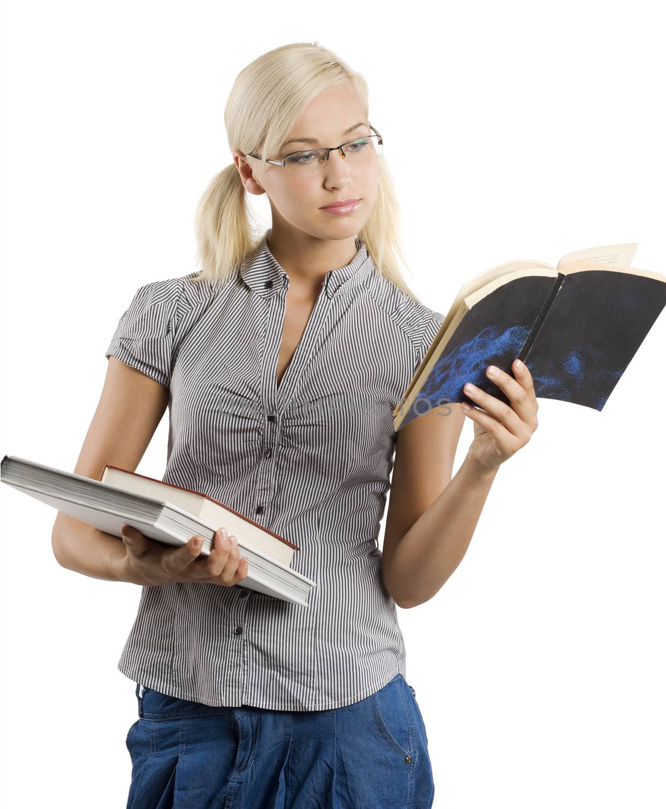 very pretty teacher in casual dress wearing glasses and reading on a book