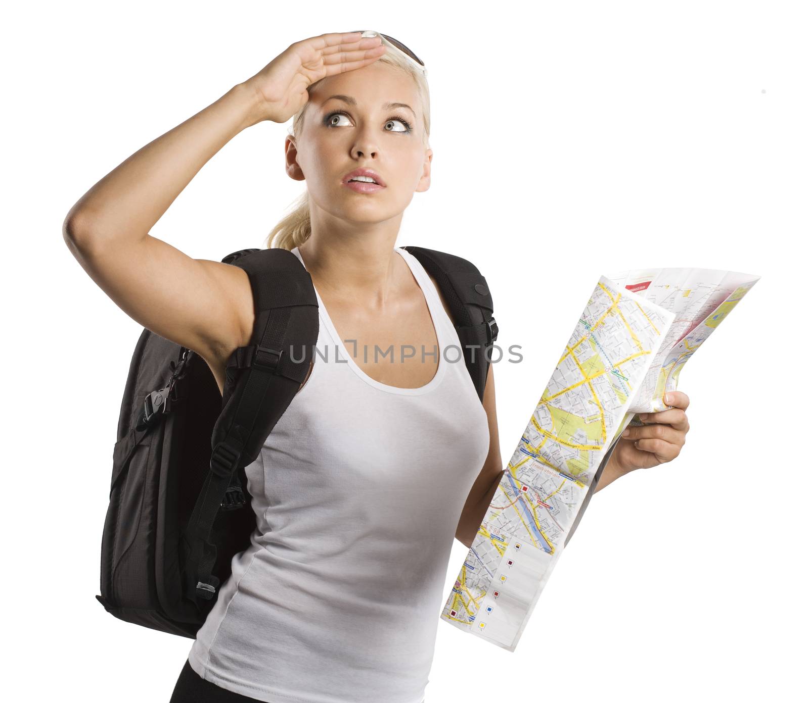 blond young woman carrying a backpack with map looking up