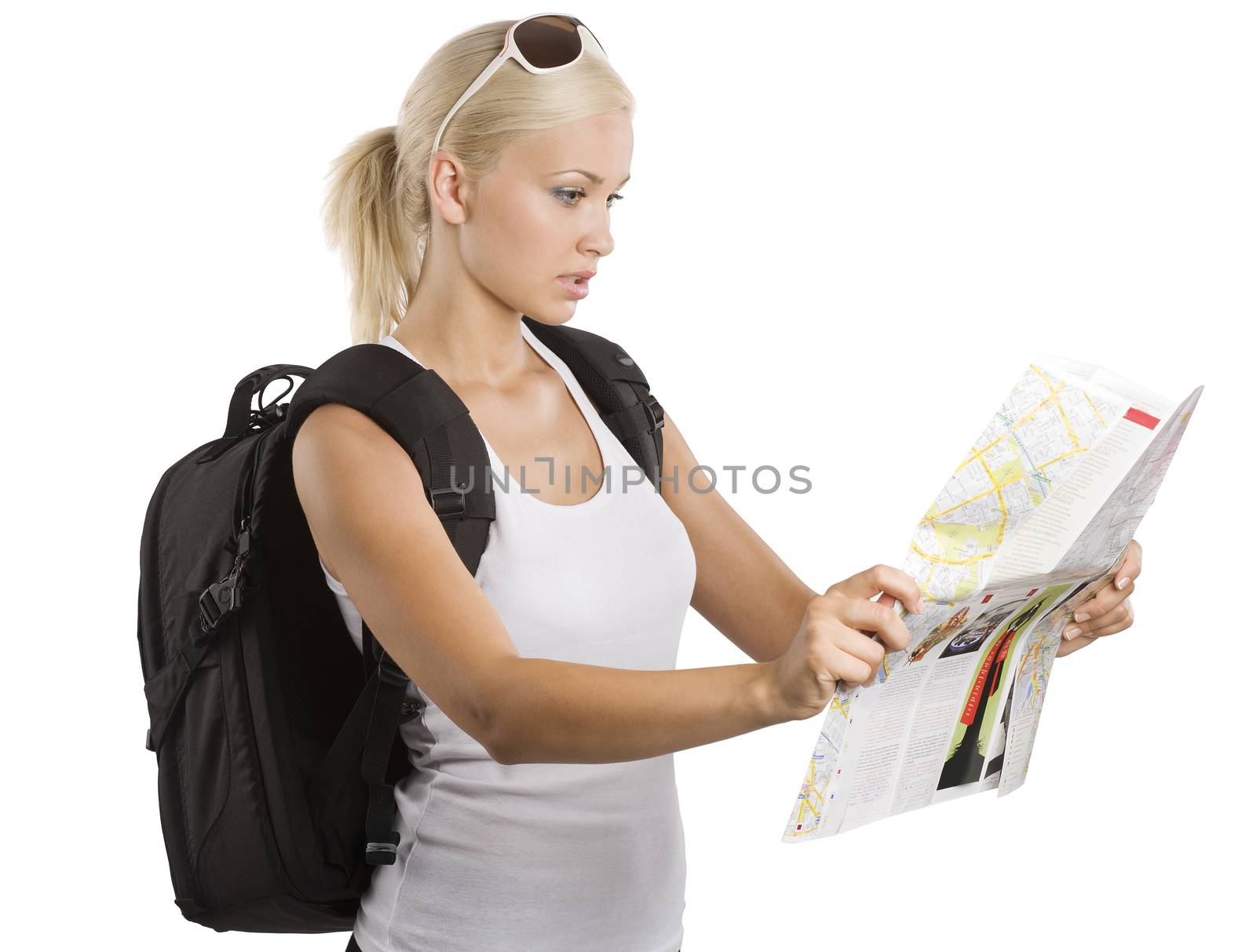 young pretty student girl in vacation looking for place on a map with rucksack