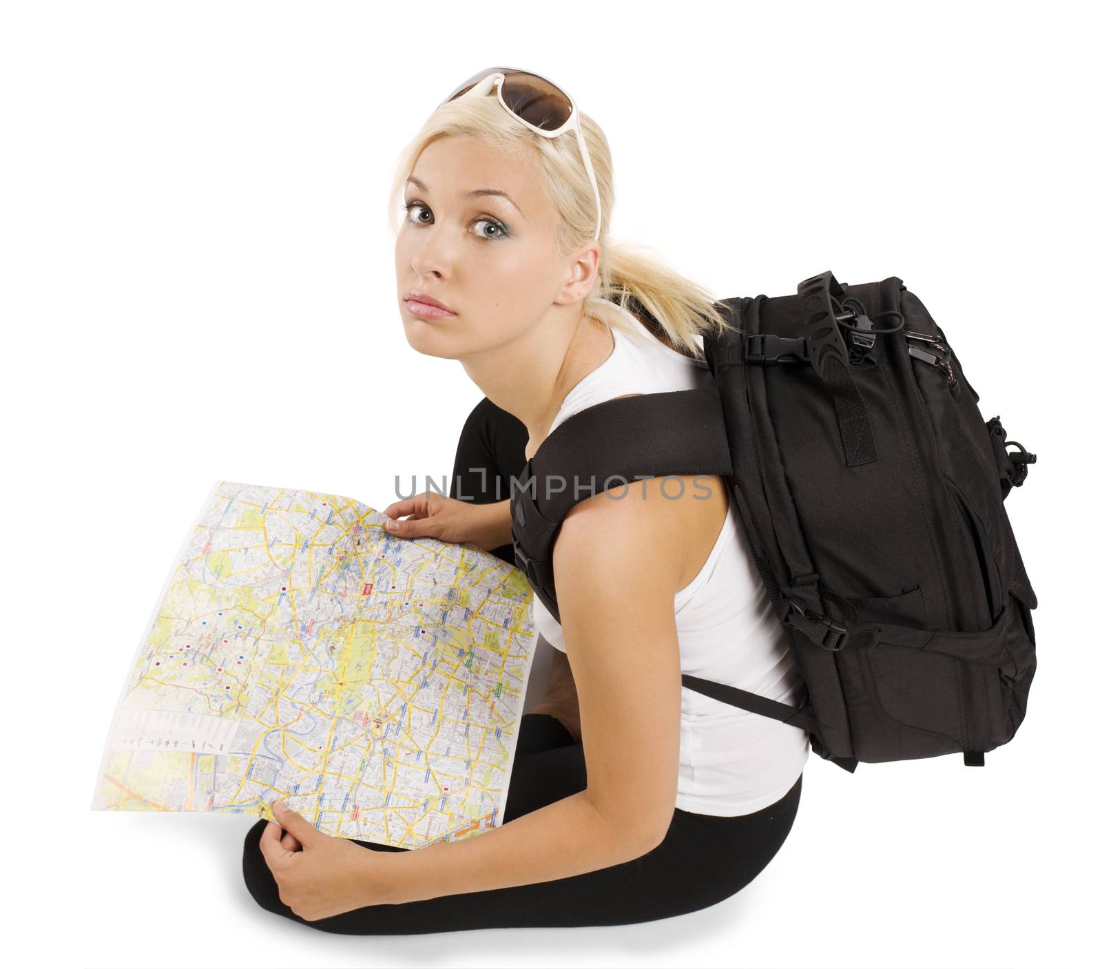 young pretty student girl in vacation with rucksack sitting and looking in camera
