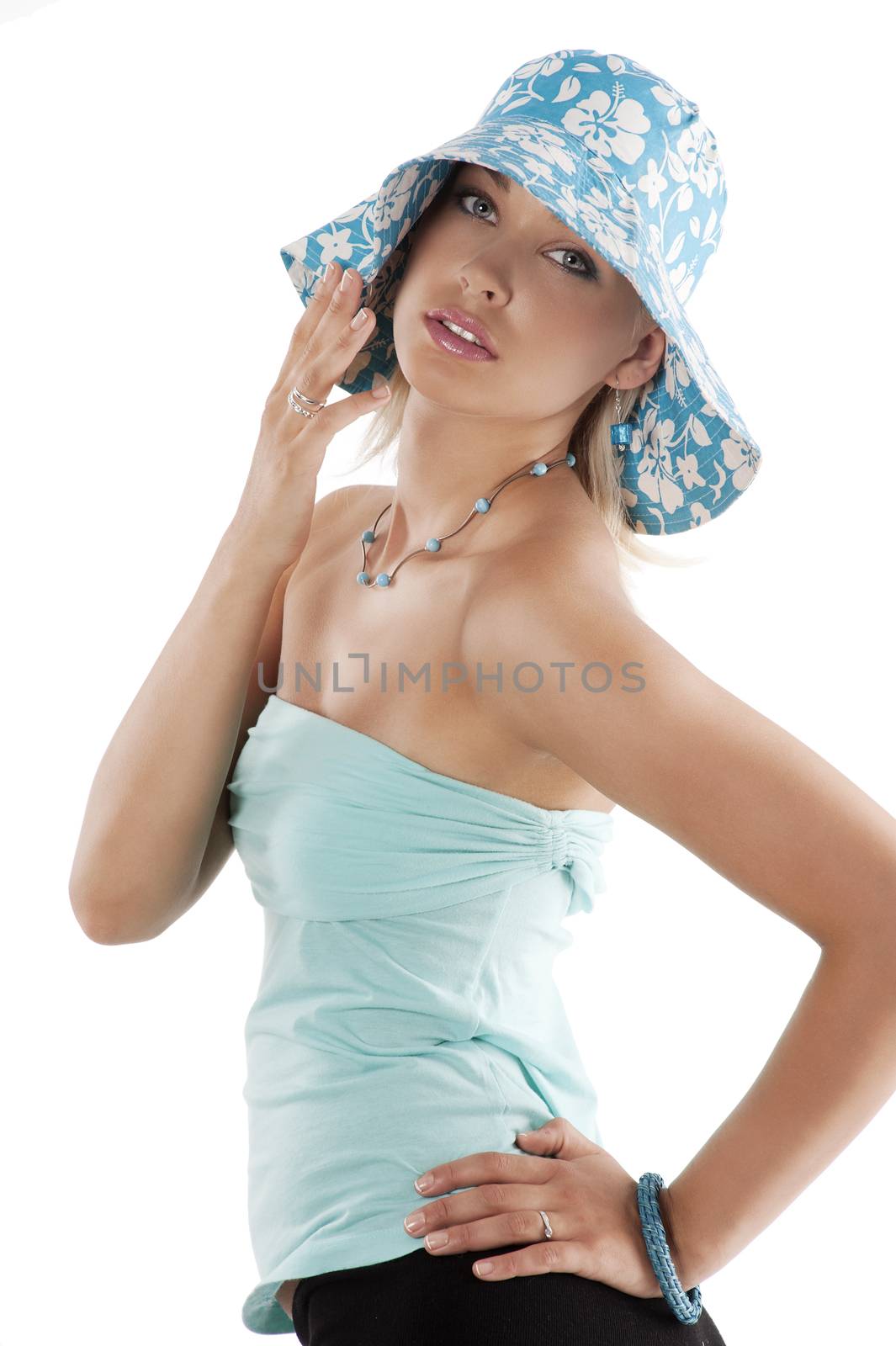 Portrait of young pretty woman in summer light blue dress with hat over white