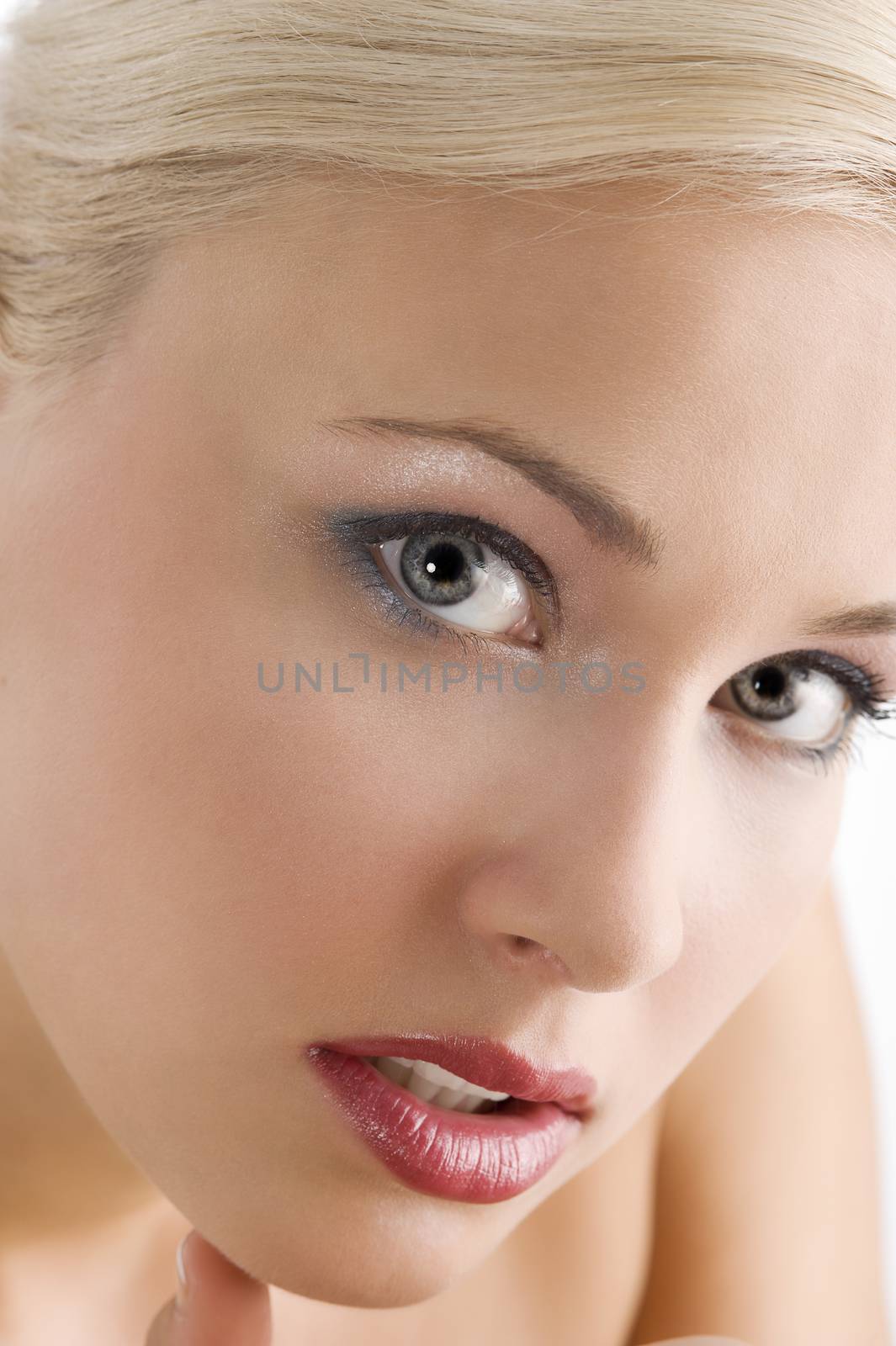 close up portrait of blond cute woman in a beauty shot looking in camera