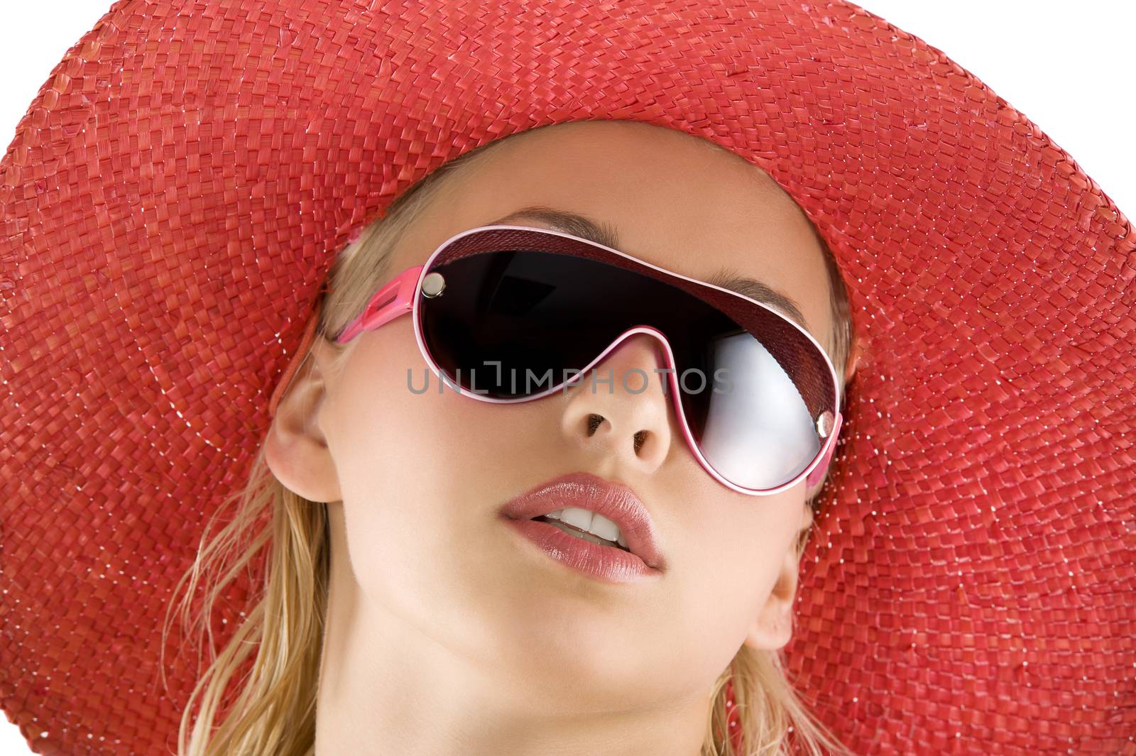 closeup portrait of pretty blond woman wearing a nice summer red hat and sunglasses