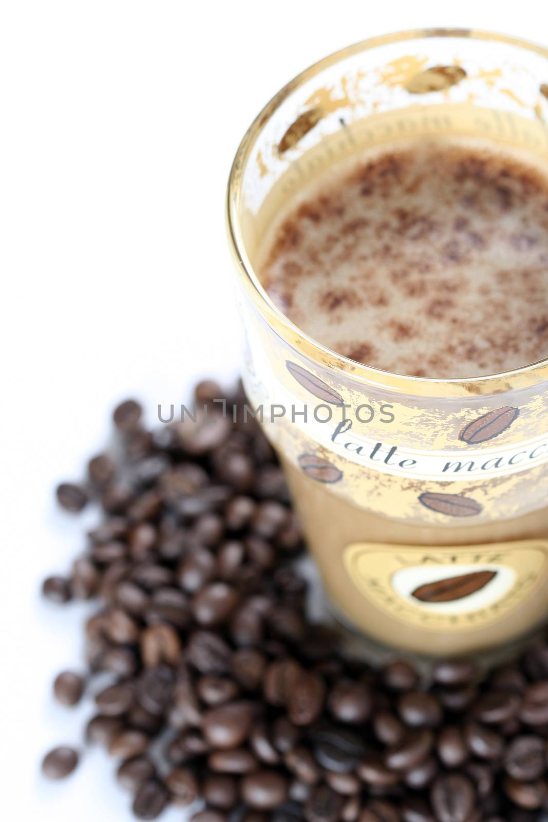 Latte Macchiato in glass costing on coffee grain