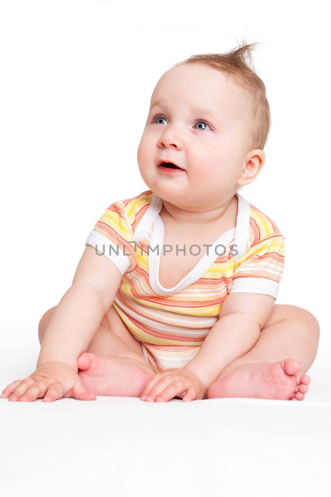 Cute baby girl sitting and looking up isolated on white background. Happy family concept.