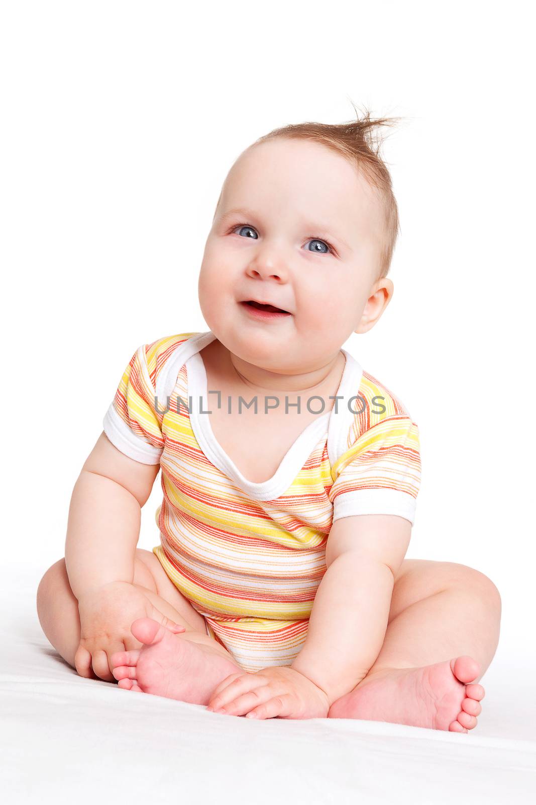 Cute adorable baby girl sitting, smiling and looking. Baby girl sitting isolated on white background. Happy family concept.
