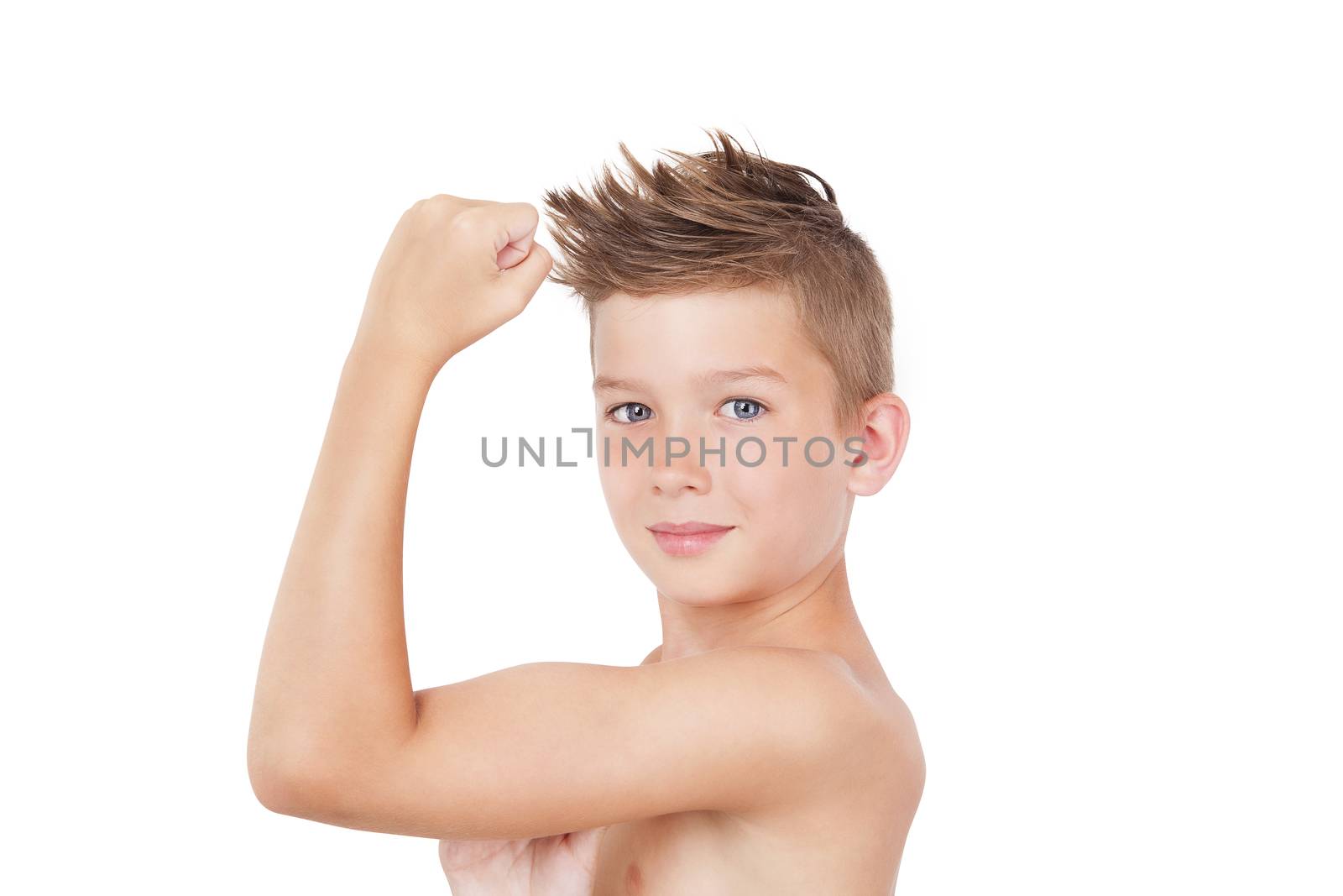 Charming shirtless boy showing biceps isolated on white background. Morning hygiene.