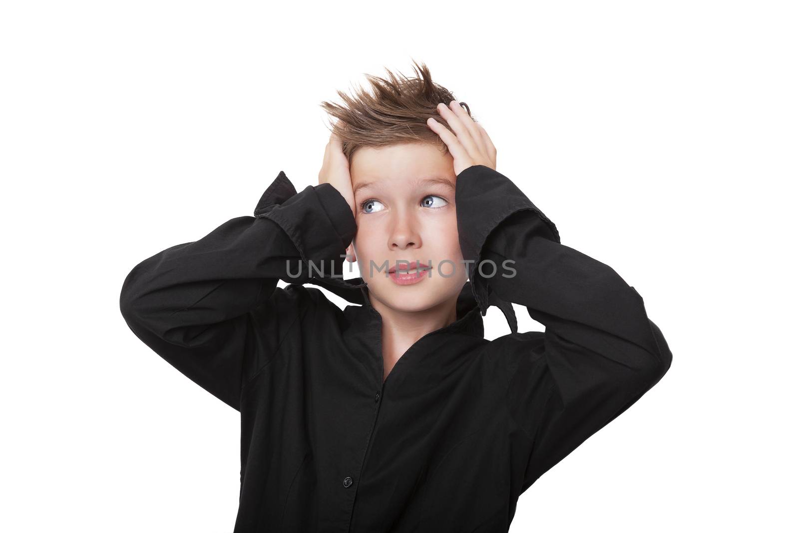 Charming expressive boy touching his head with both hands isolated on white background.
