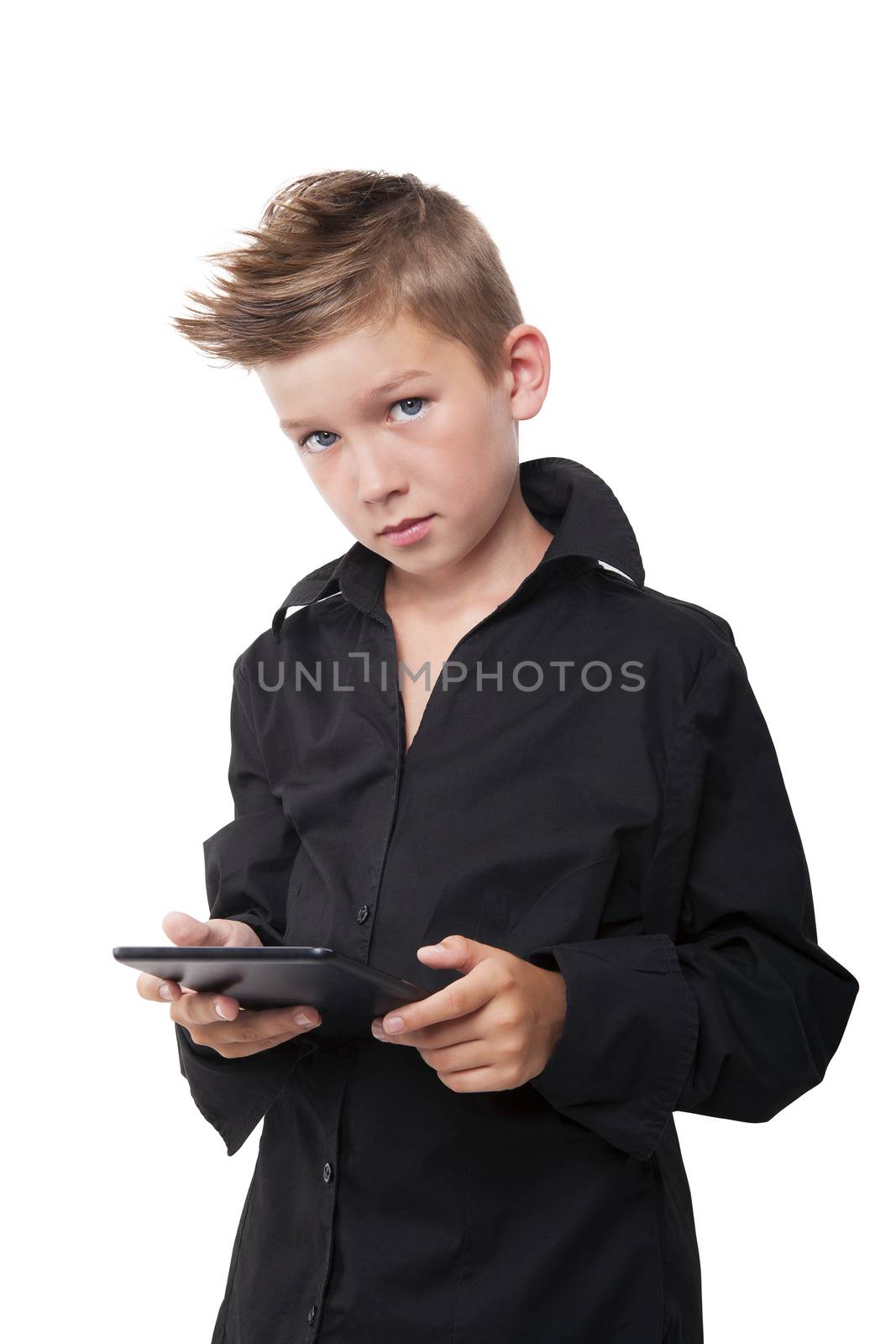 Young casual boy in fashionable black dress shirt working on tablet isolated on white.