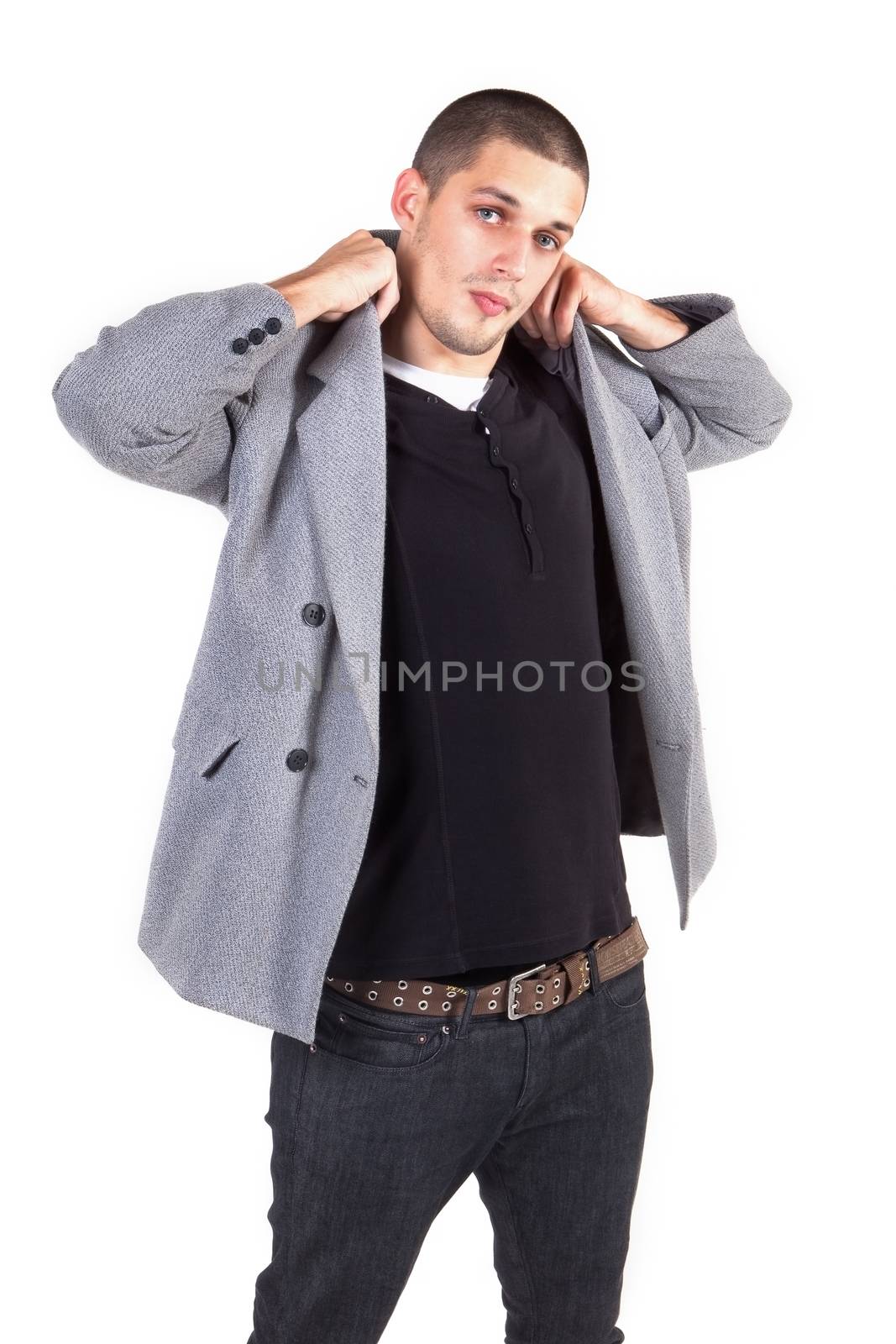 Young attractive male fashion model posing. Looking into the camera, isolated on white background. Youth fashion.