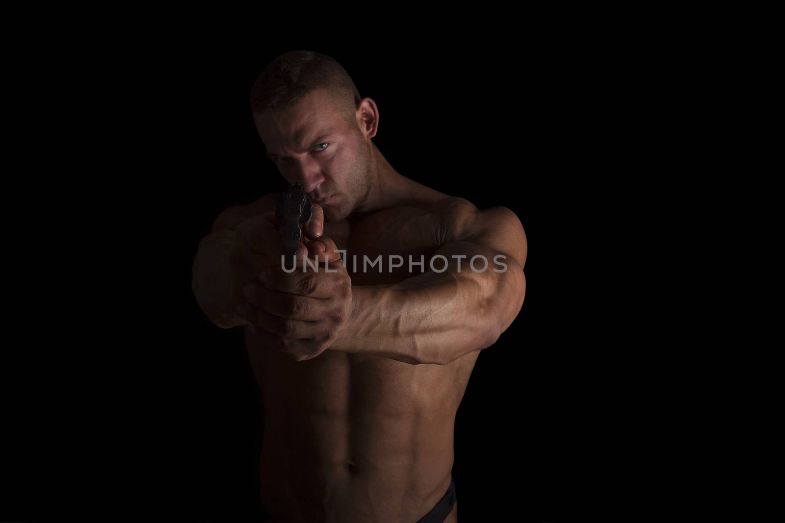 Proud muscular serious officer aiming gun on camera. Crime and security concept. Busted.