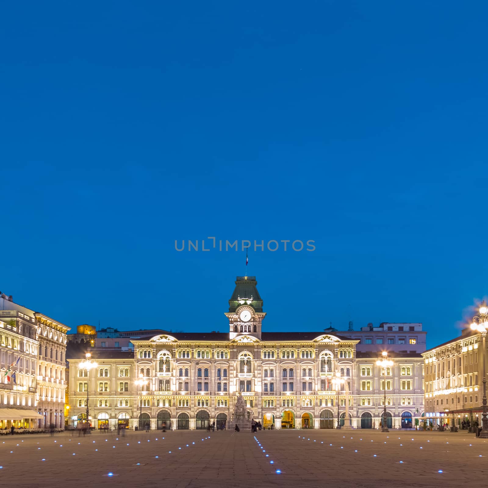 The City Hall, Palazzo del Municipio, is the dominating building on Trieste's main square Piazza dell Unita d Italia. Trieste, Italy, Europe. Illuminated city square shot at dusk.