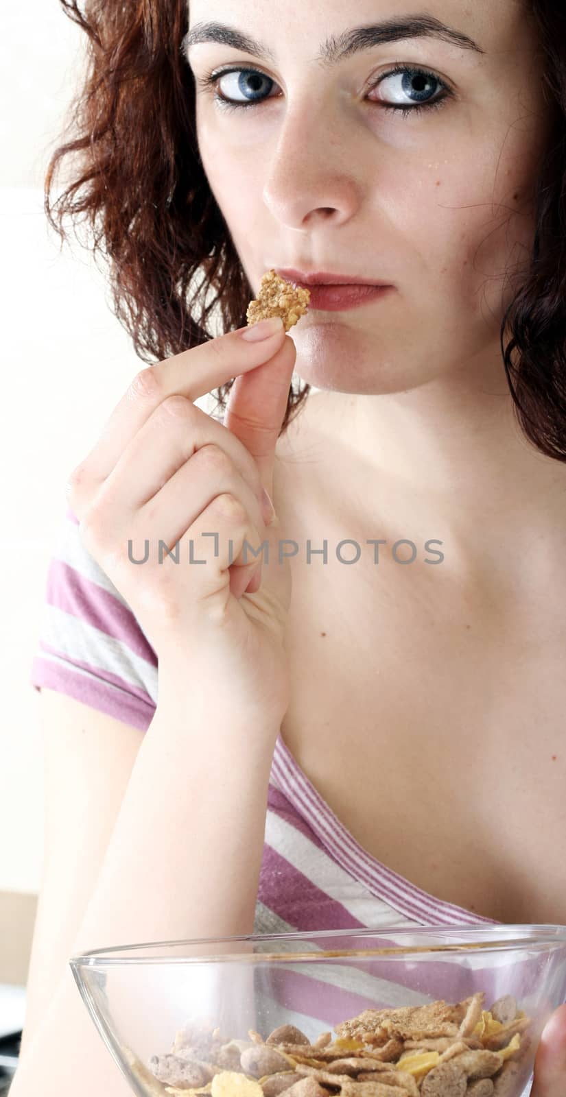 Young people eating milk with cereals by arosoft