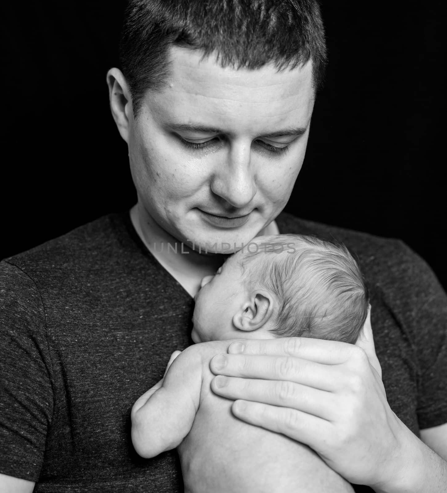 Father holding a newborn baby boy, 11 day old