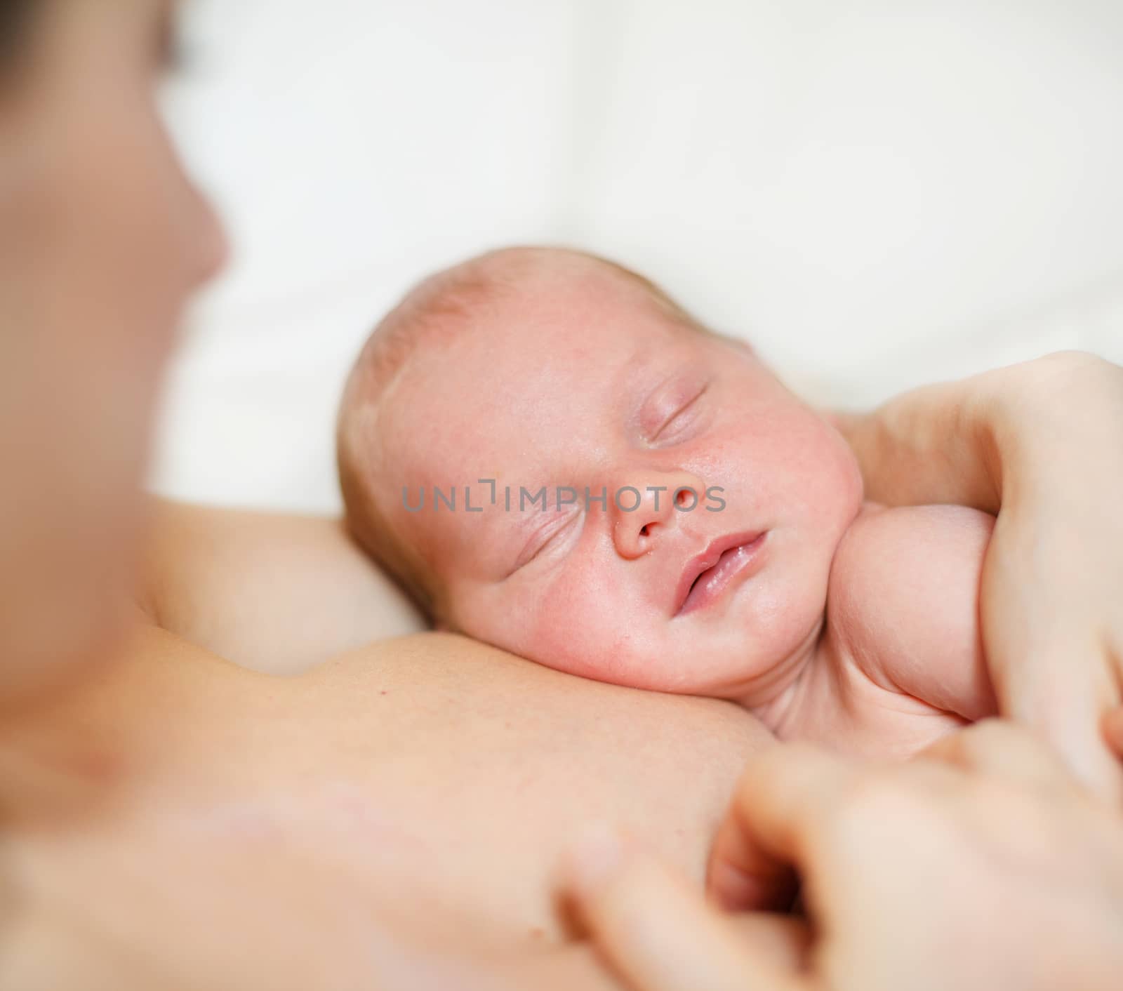 Close Up of sleeping newborn baby Aged 11 Days on mother's chest