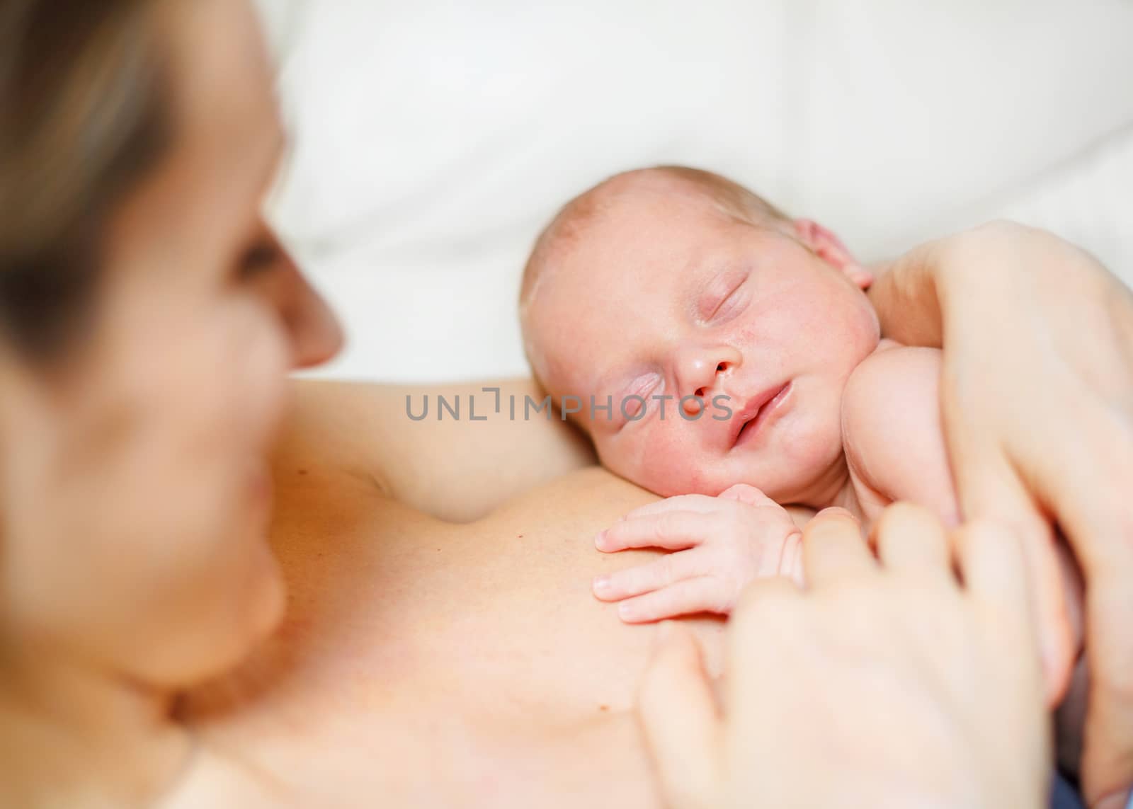 Close Up of sleeping newborn baby Aged 11 Days on mother's chest